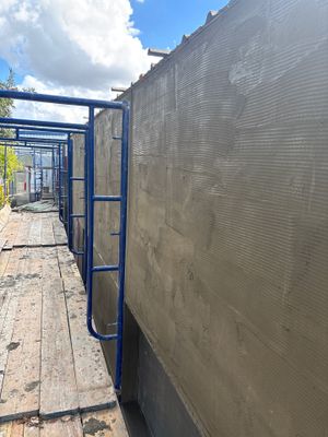 Scaffolding set up against a wall during construction work