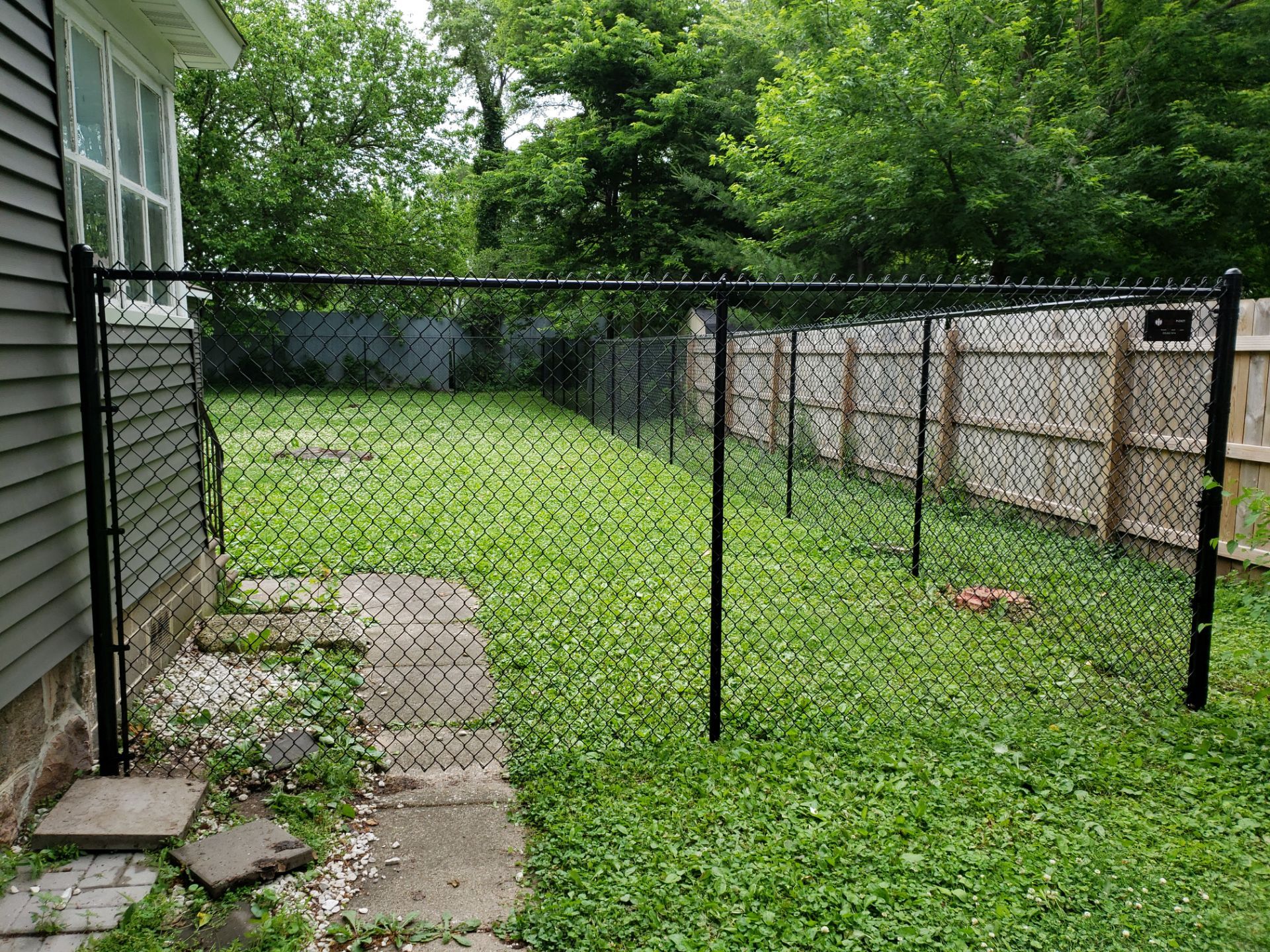 Black Vinyl Chain Link Fence Installation in Charles City by Perfect Picket Fence and Stain