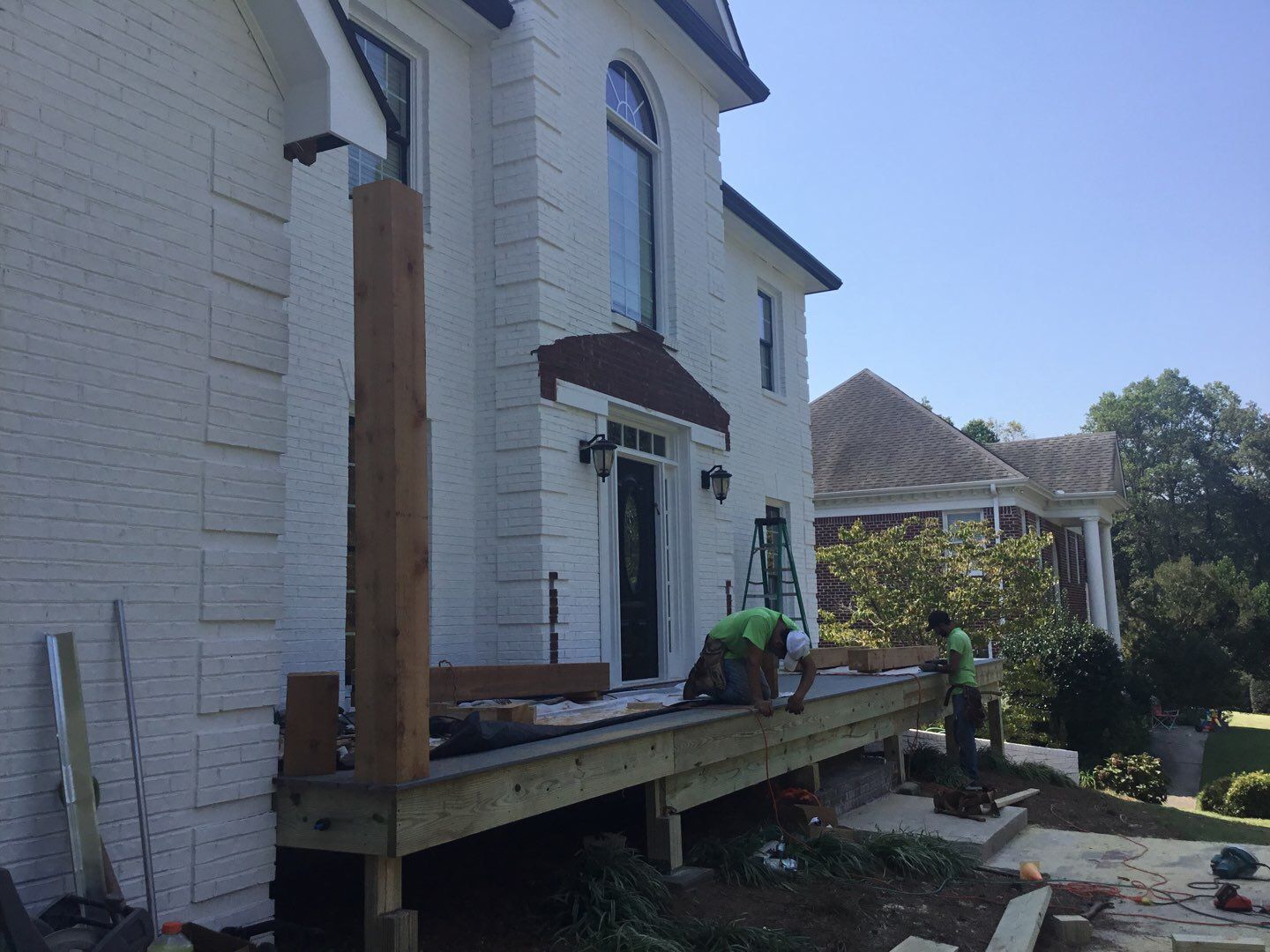 Custom Front Porch Construction with White Railing in Dunwoody by Swift Home Renovations