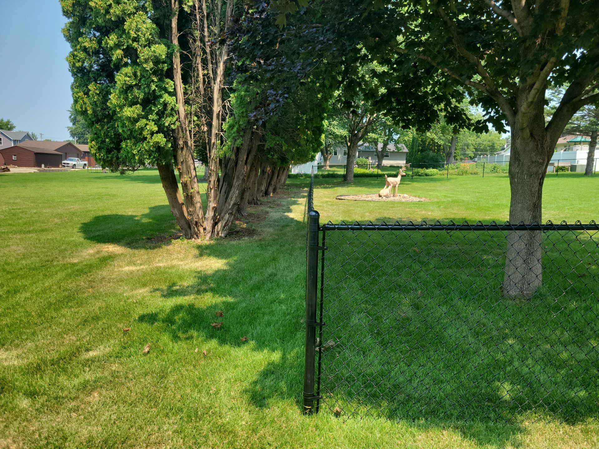 Black Vinyl-Coated Chain Link Fence Installation in New Hampton by Perfect Picket Fence and Stain