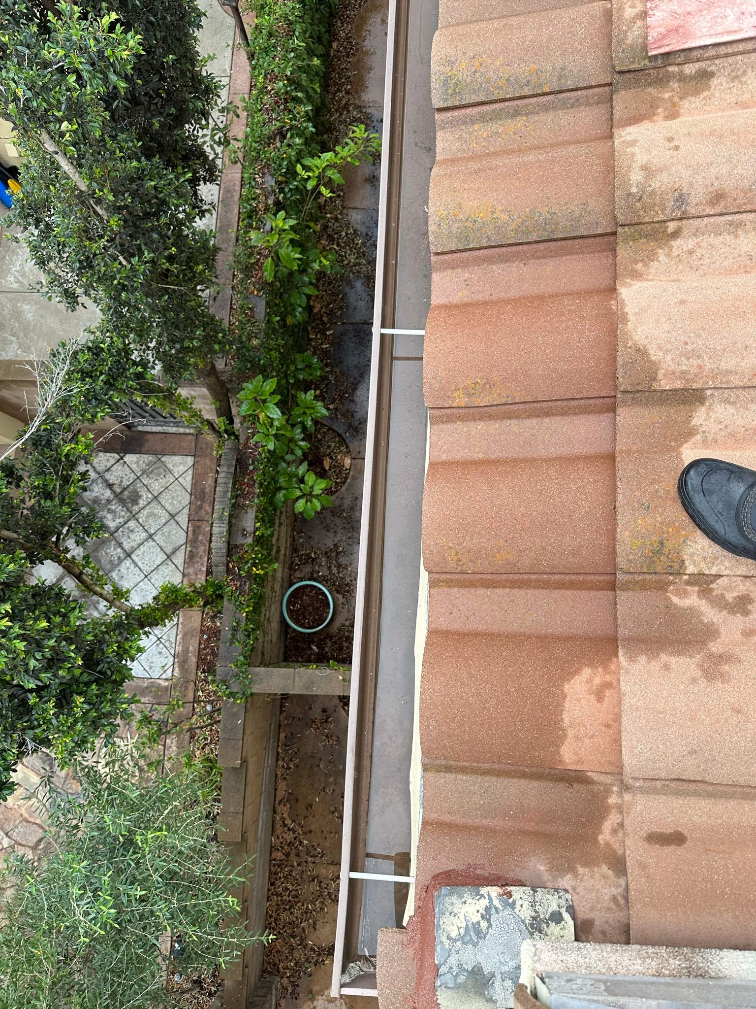 Clogged gutters at this Irvine home in Woodbury by Property Cleaning Experts, LLC
