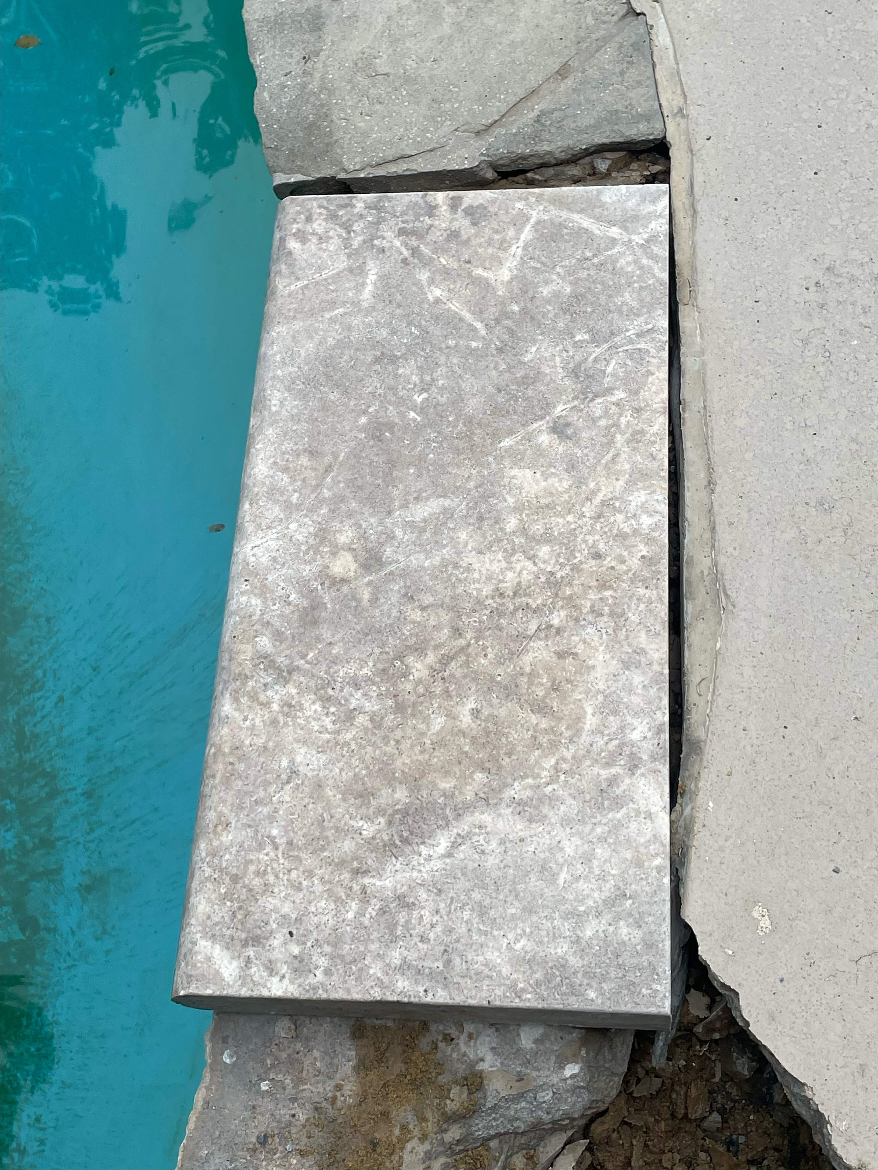 Pool Surround remodel with retaining walls, new waterfall and water slide by Fairfax Contractors, LLC