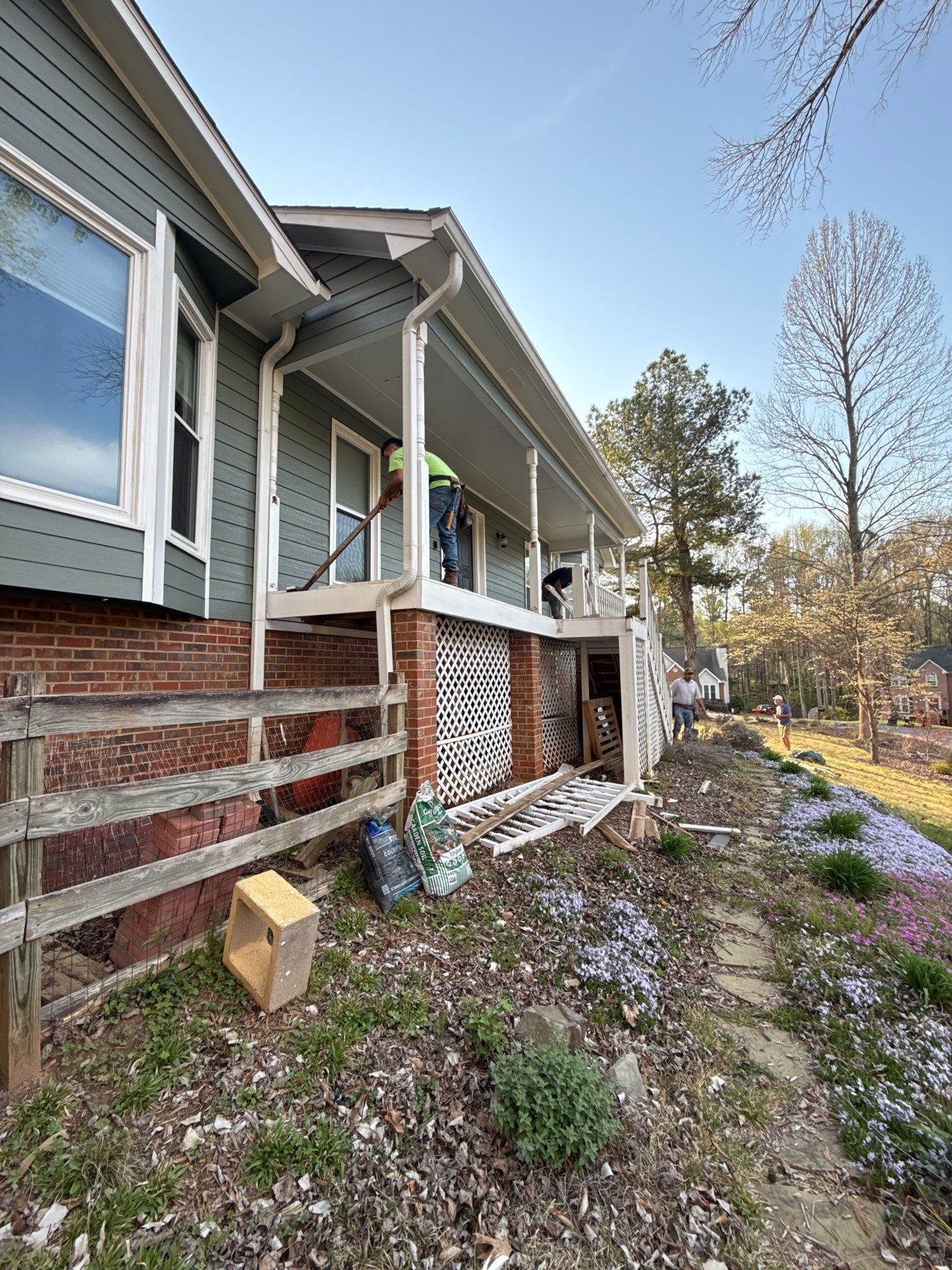 Composite Deck and Porch Renovation With Black Metal Railings by Swift Home Renovations 