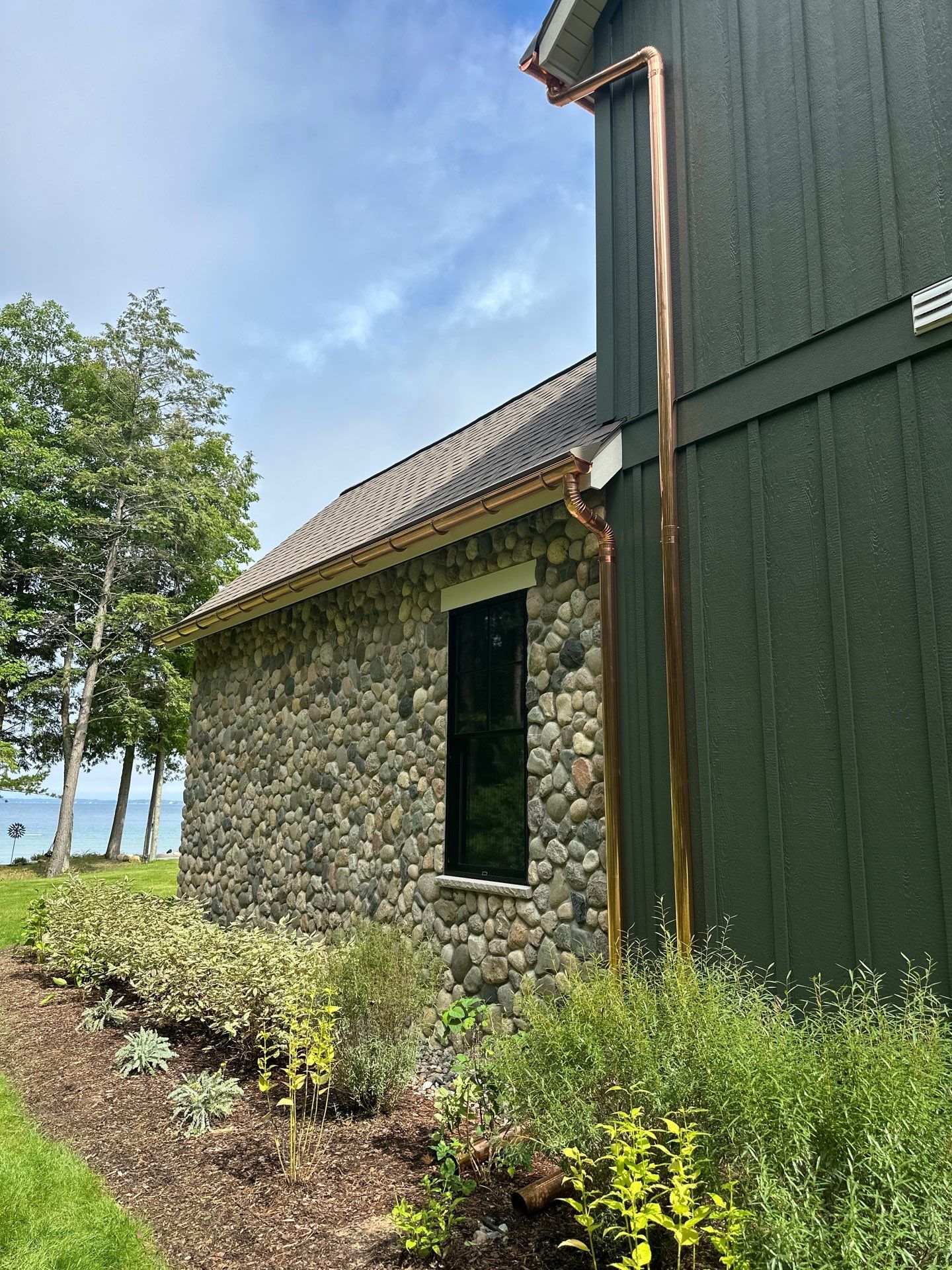 Copper Gutter and Downspout Installation for Omena Residence by Rainbow Seamless Systems