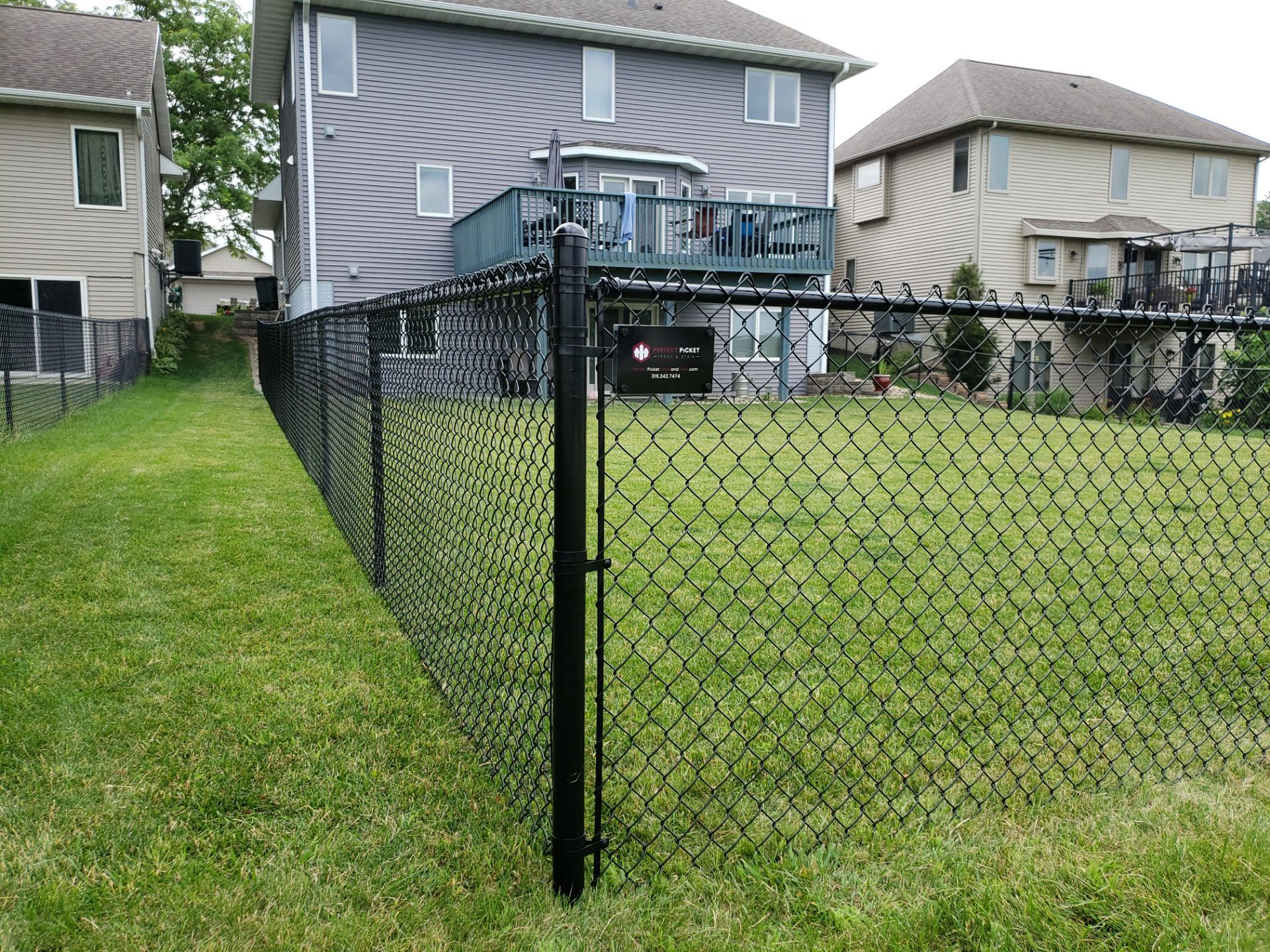 Black Vinyl Chain Link Perimeter Fence Installation in Waterloo by Perfect Picket Fence and Stain