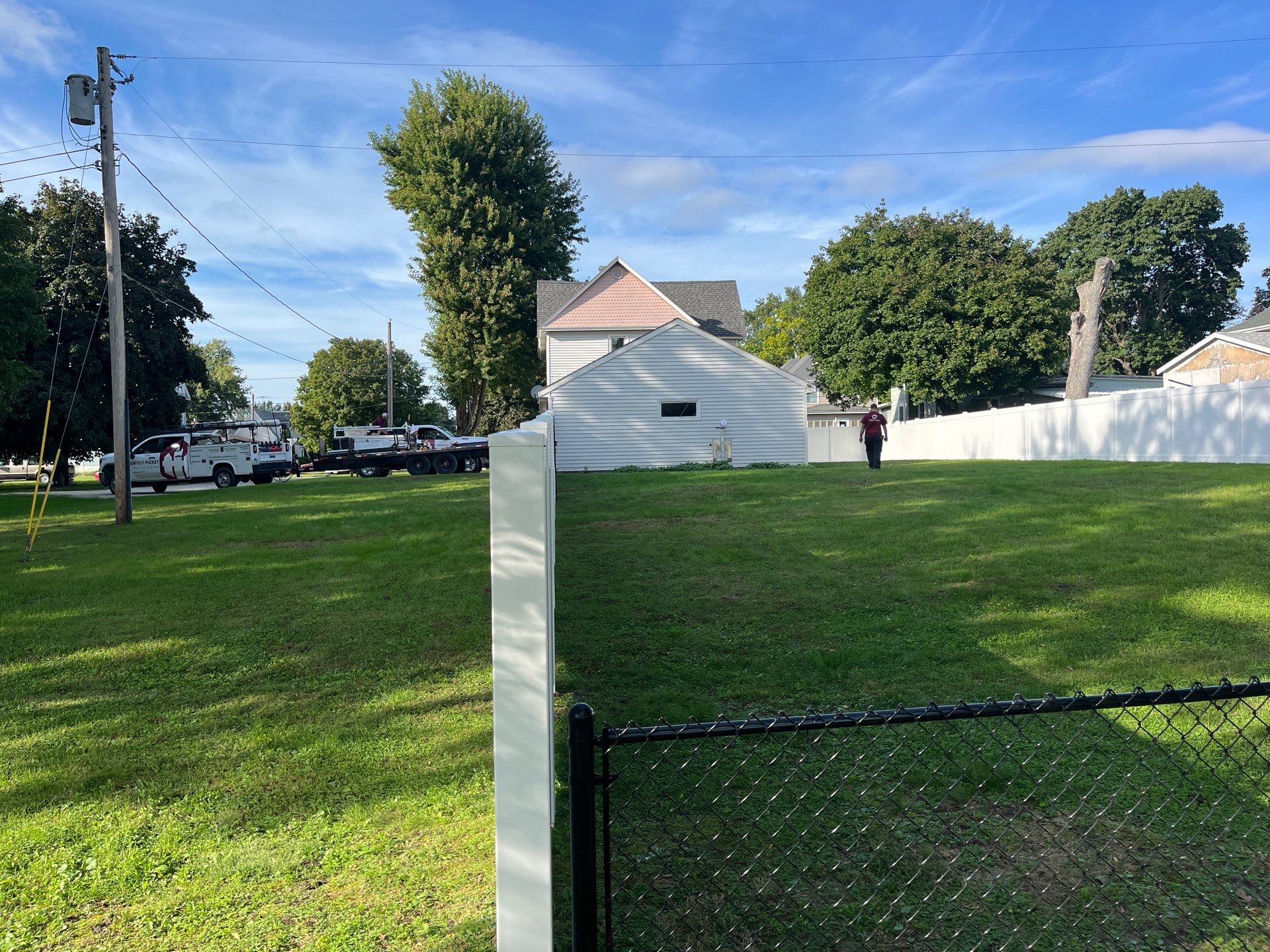 White Vinyl Privacy Fence and Black Chain Link Installation in Sumner by Perfect Picket Fence and Stain