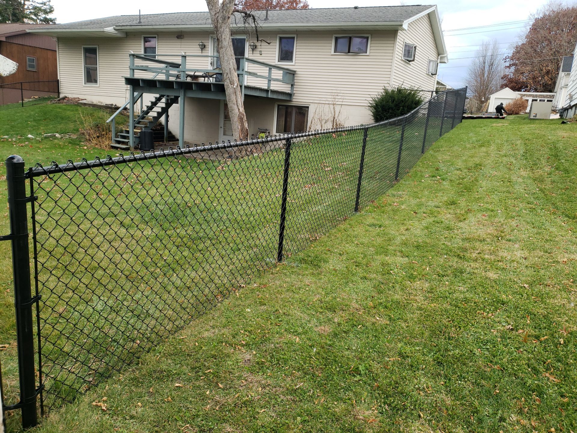 Residential Black Vinyl-Coated Chain Link Fence in Grundy Center by Perfect Picket Fence and Stain