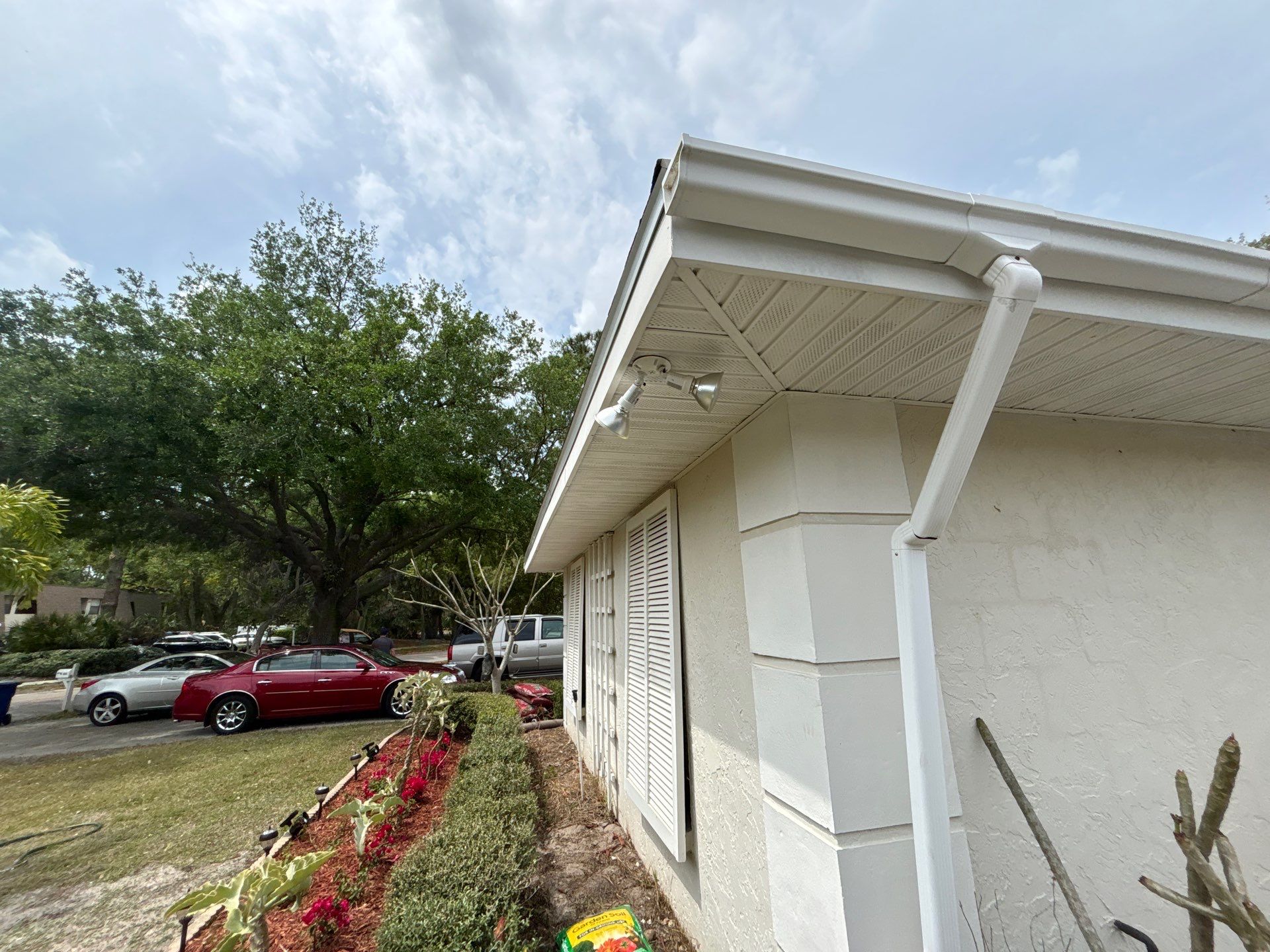 Gutter Project with White 6-K Seamless Gutters Installation and Downspouts in Sarasota FL by Gutter Professors