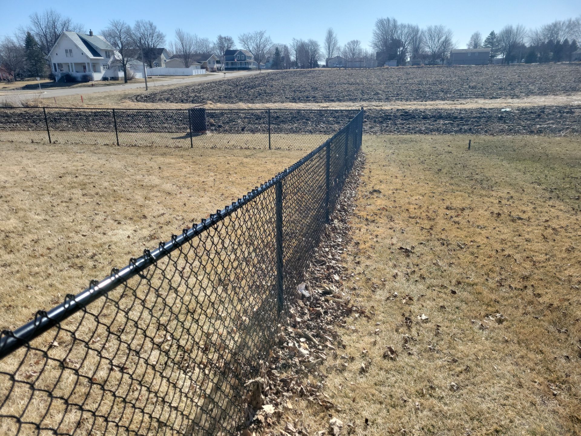 Residential Black Chain Link Fence and Gate Installation in Tripoli by Perfect Picket Fence and Stain