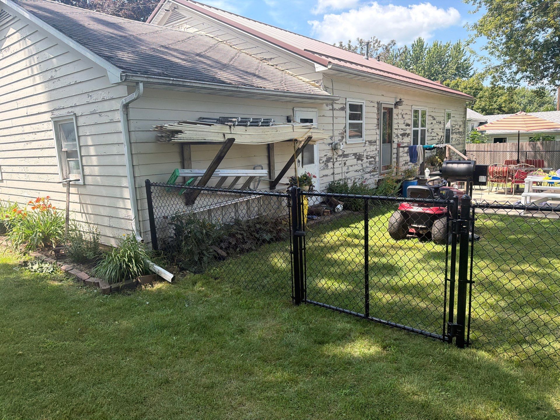 Black Chain Link Backyard Fence Installation in Tripoli, IA by Perfect Picket Fence and Stain
