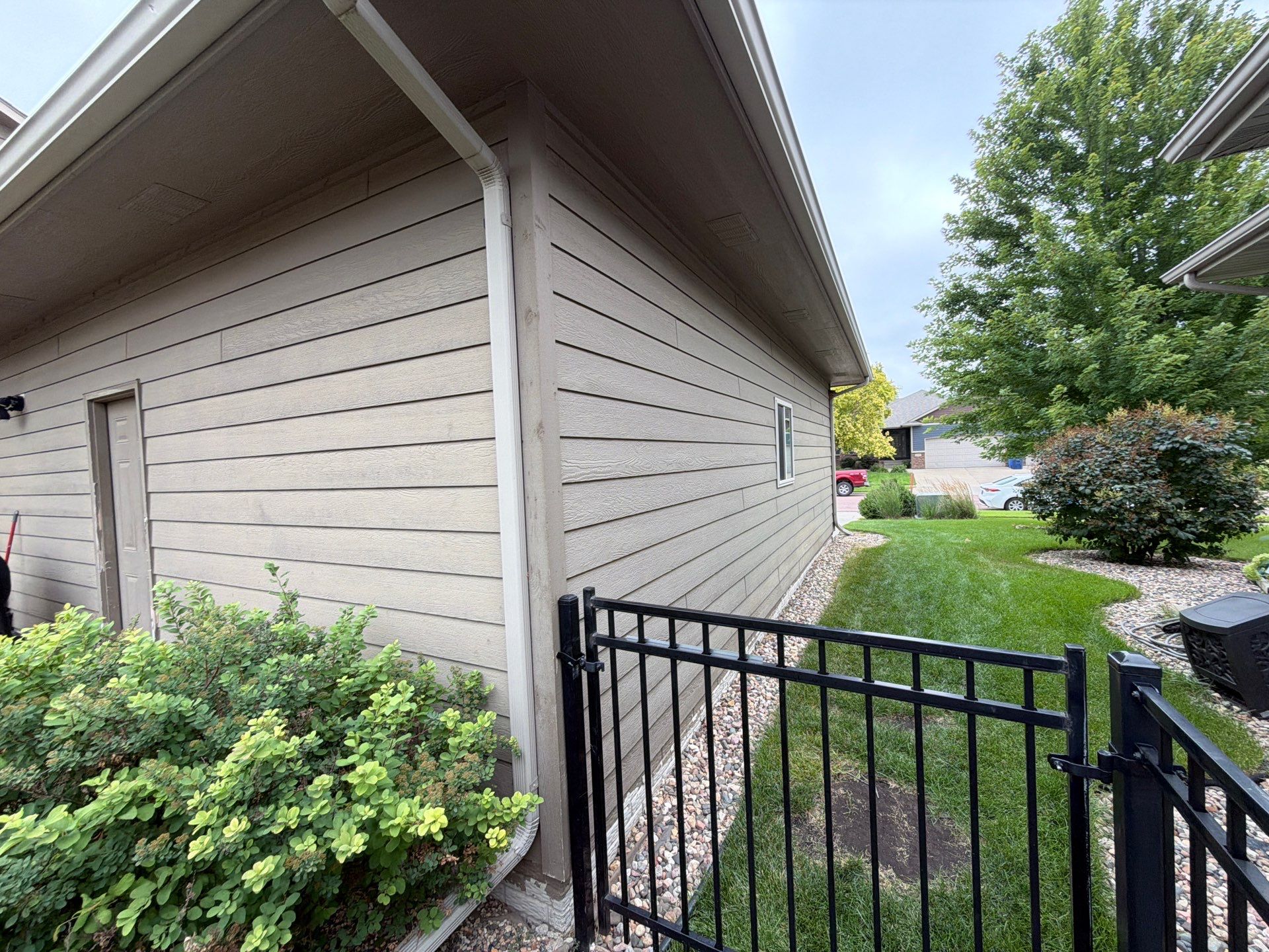 Full Exterior Siding Repaint for Sioux Falls Home and Garage by Select Painting, Coatings & Garage Cabinets