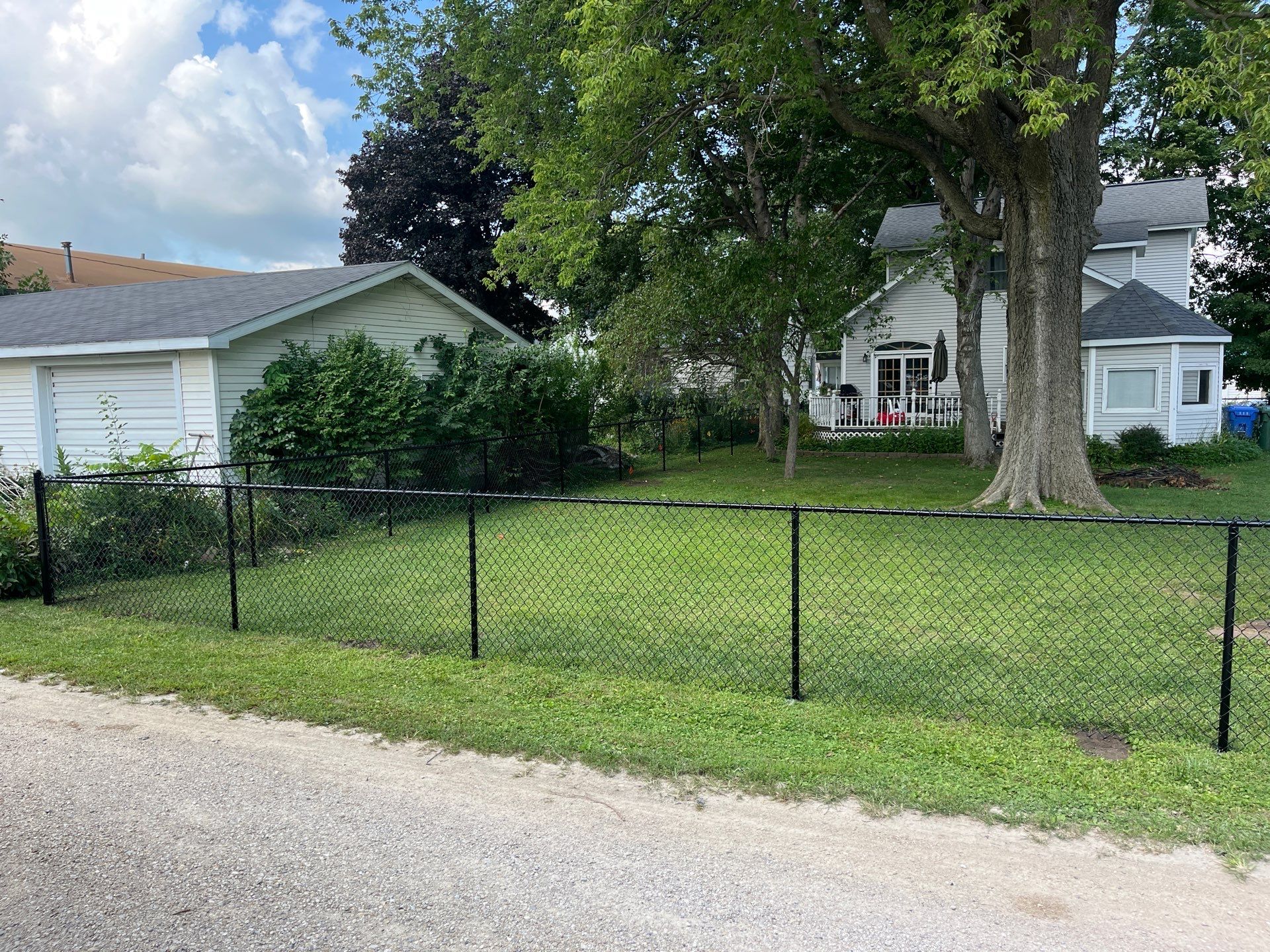 Black Chain Link Perimeter Fence and Gate Installation in Shell Rock by Perfect Picket Fence and Stain