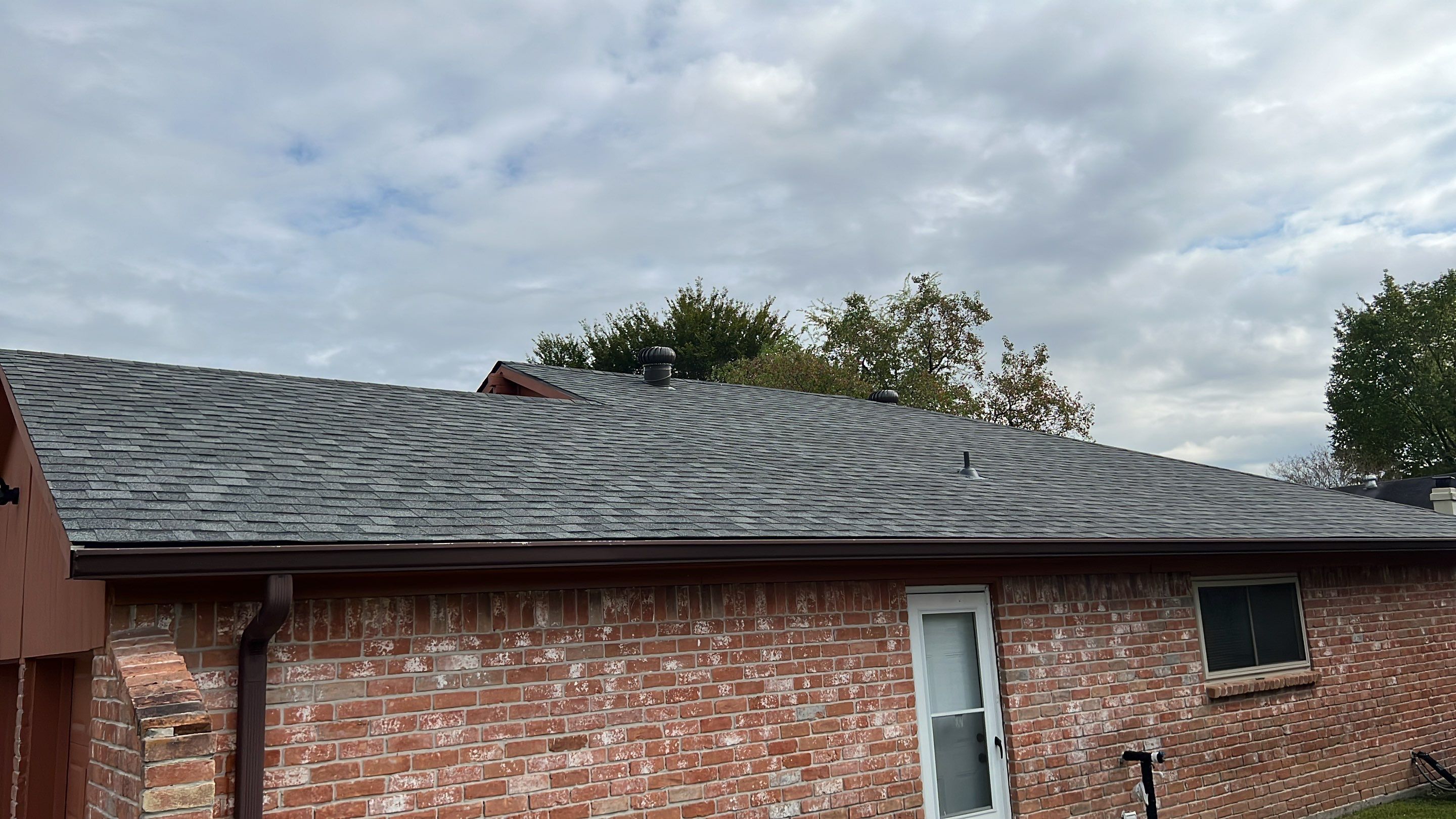 New Gray Shingle Roof on Brick Home — Houston, TX by PL Roofing & SB Roofing, LLC.