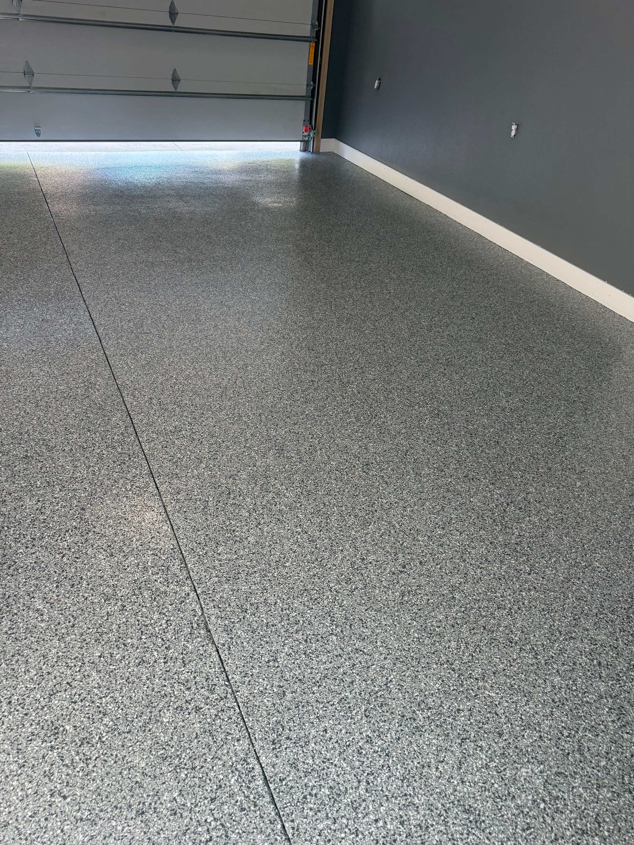 Custom Garage Floor Coating and Backyard Patio Refinishing in Tyndall by Select Painting, Coatings & Garage Cabinets