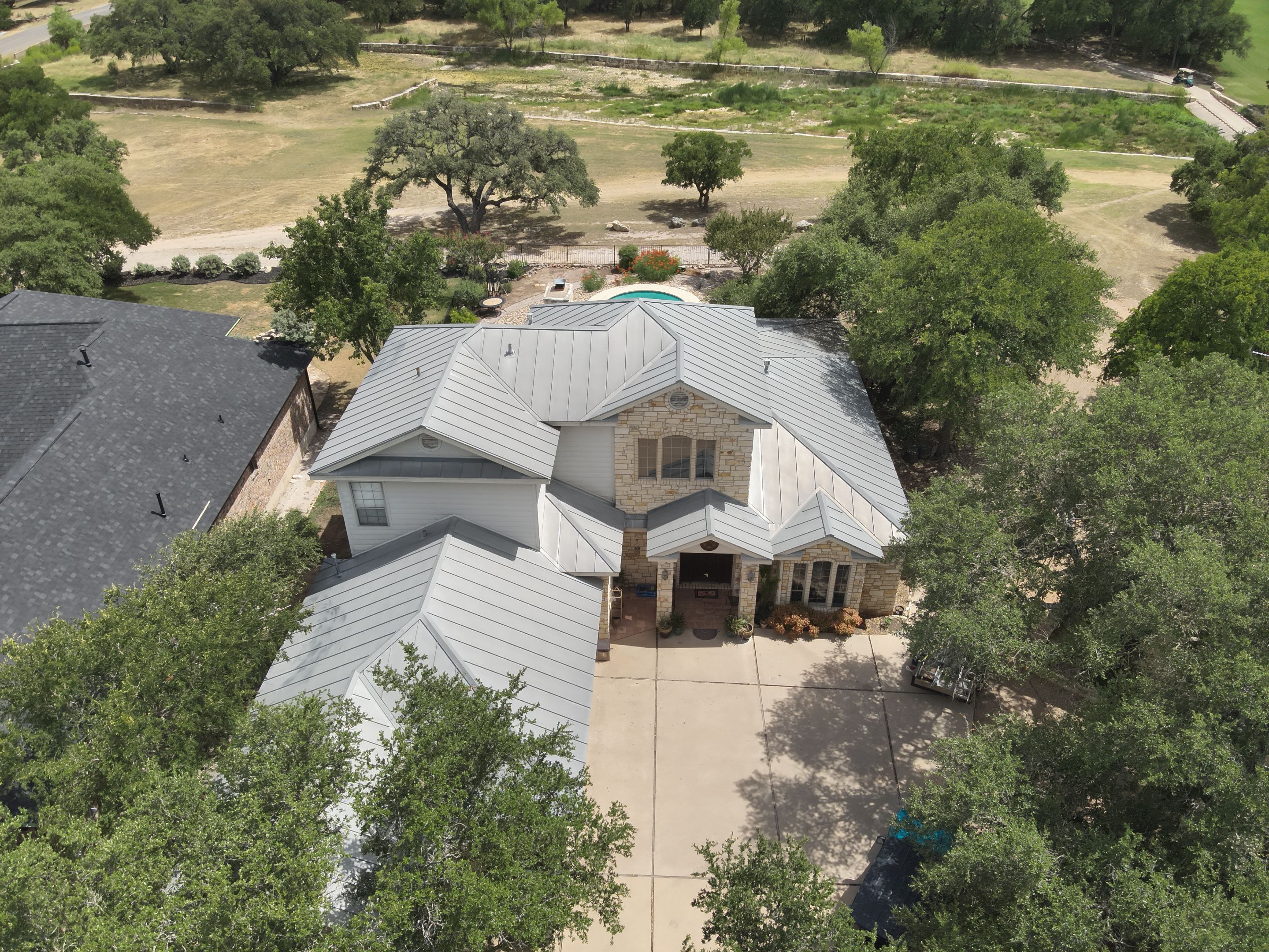 Residential Roof Replacement using 24 GA Double-Lock - Surrey Beige by Action Exteriors Austin