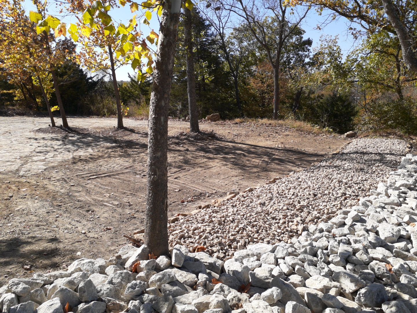 Supporting back of home with backfill at edge of steep creek by LAND ESCAPES LLC