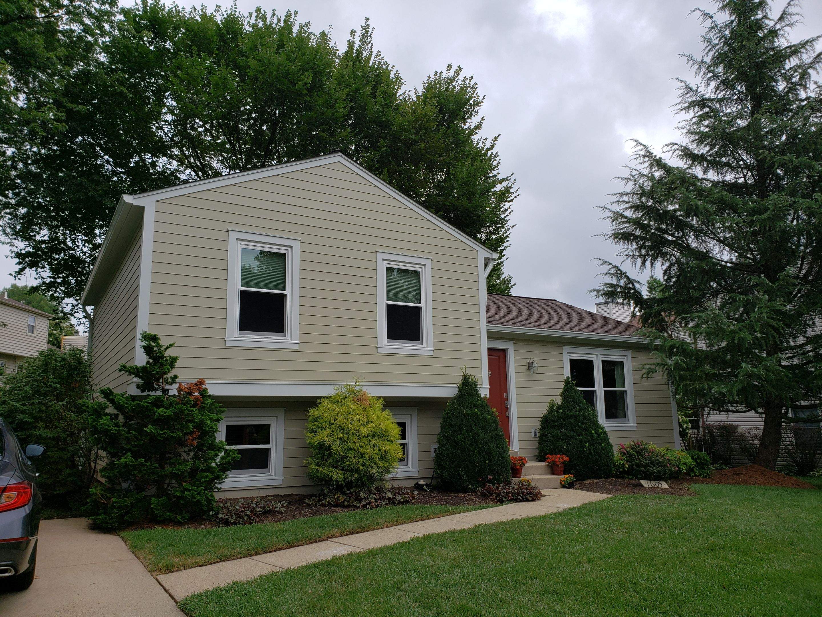 New composite windows and fiber cement siding with trim and gutters by Window Depot of Annapolis