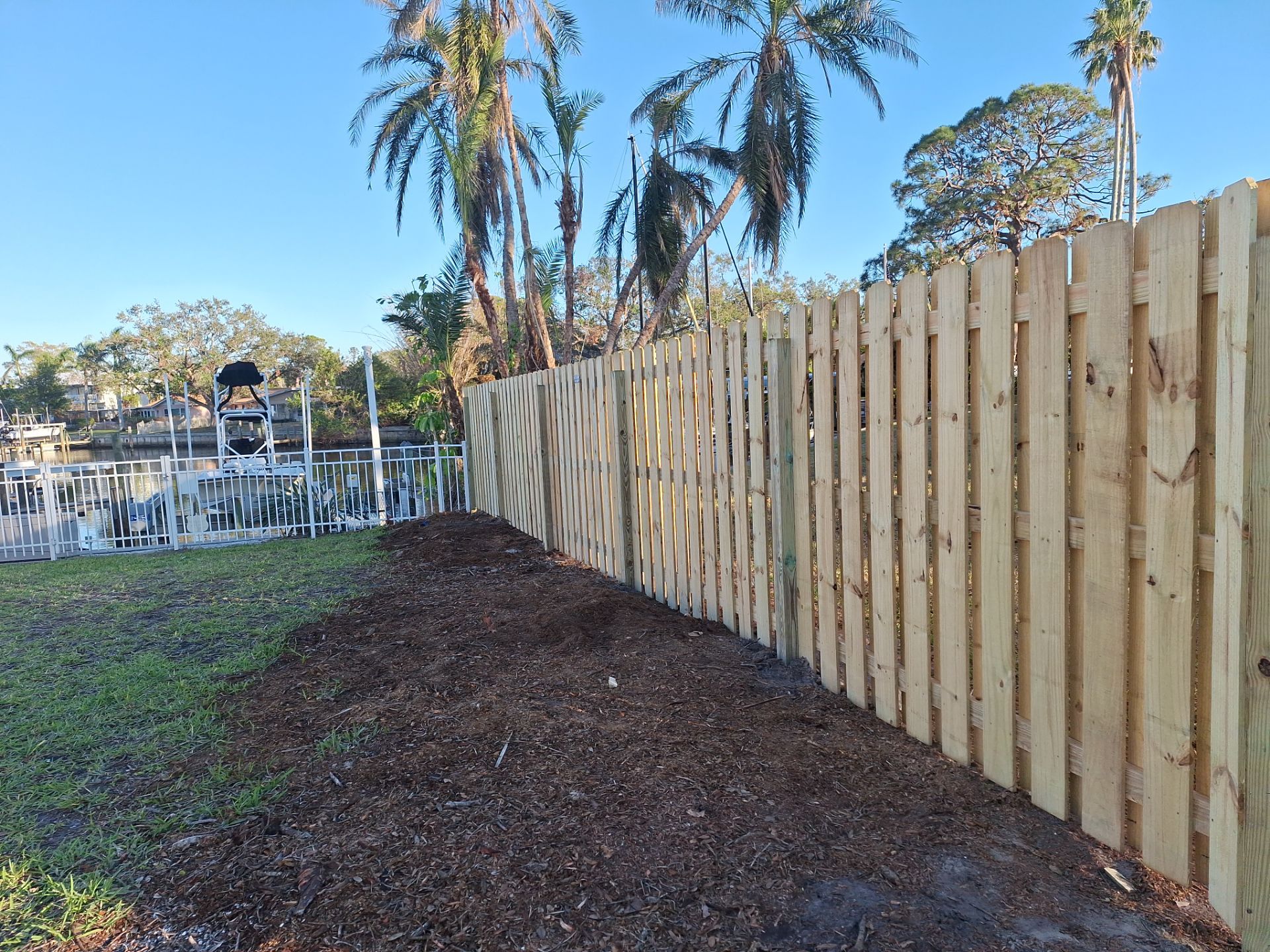 Wood Fence Installation using 6ft Pressure-Treated Wood Board-On-Board Privacy Fence with a 4Ft 3 Rail White Aluminum Fence by Asap fence and gates, LLC