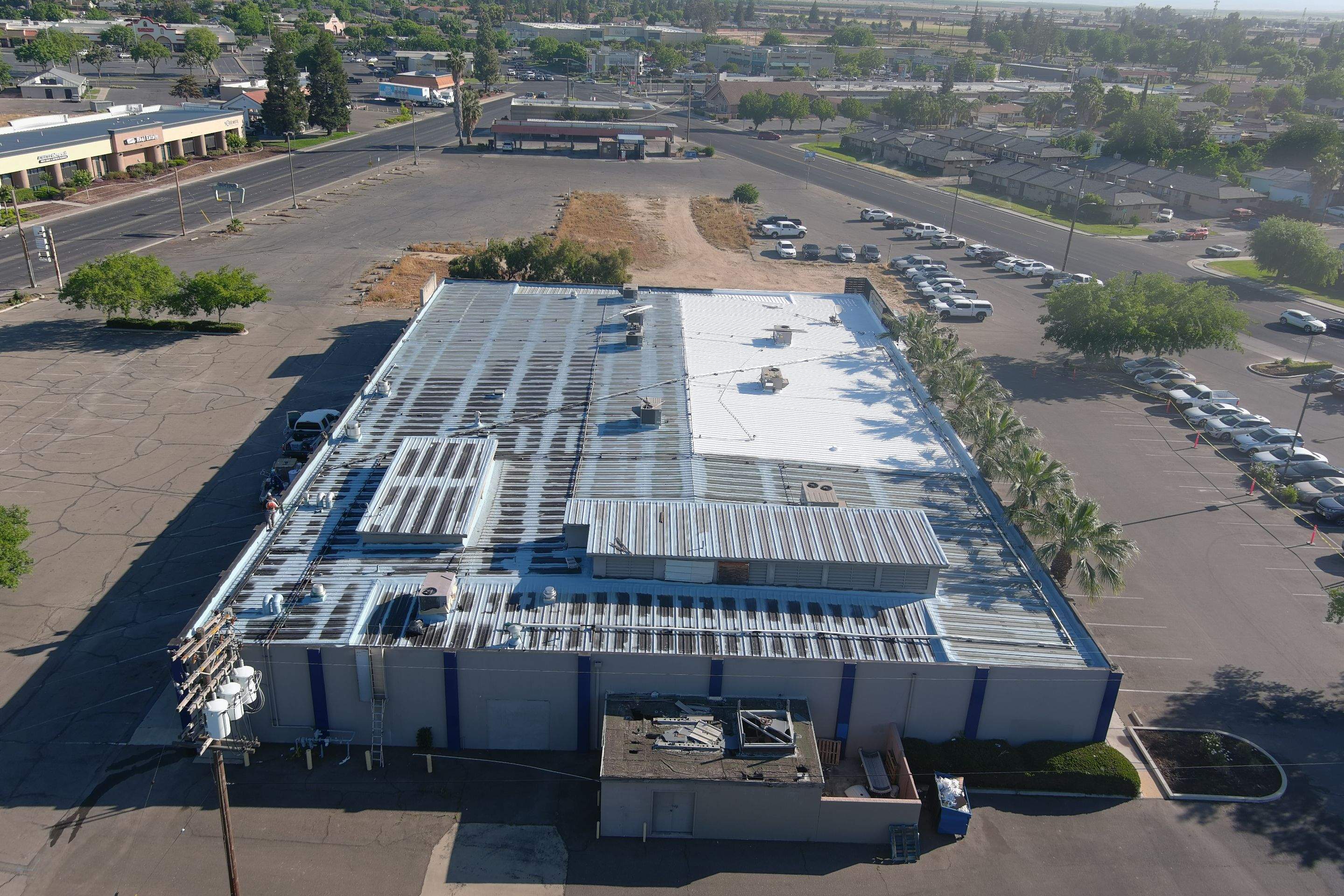 Metal roof restoration on commercial roof using Conklin Benchmark/ PUMA XL acrylic coatings over metal and foam by Straight Edge Roofing Inc