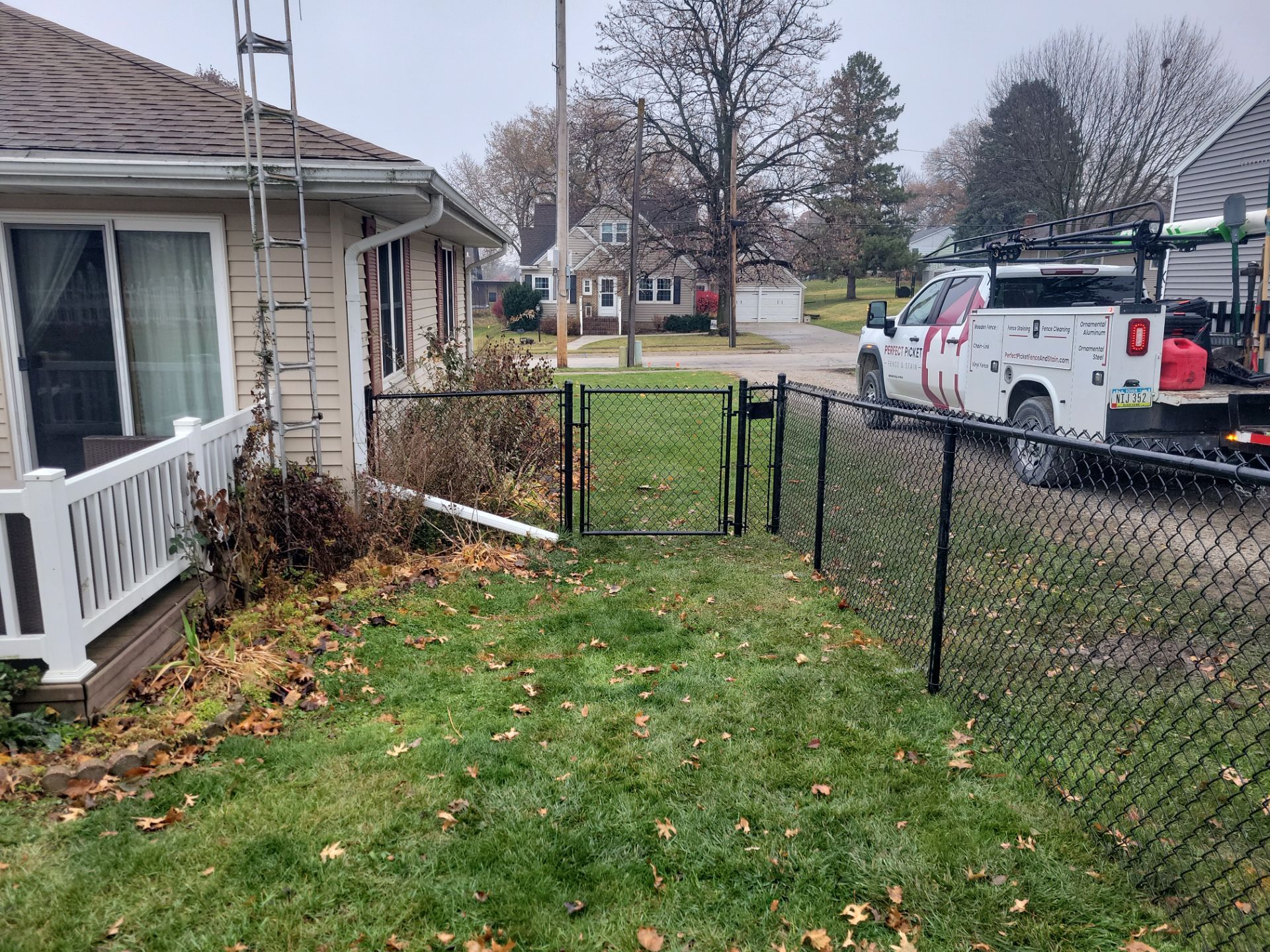 Black Vinyl-Coated Chain Link Fence Installation in Aplington by Perfect Picket Fence and Stain