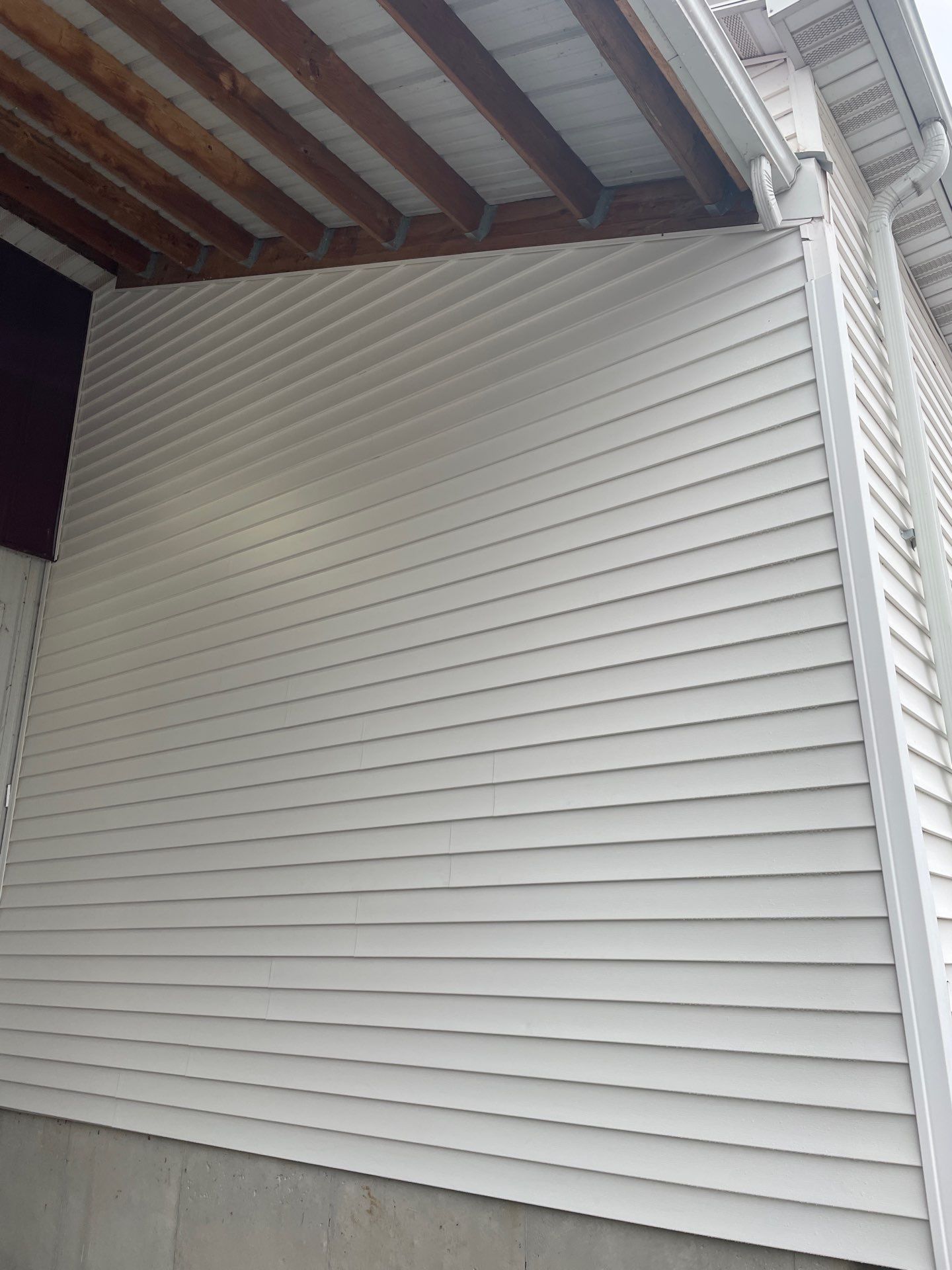Siding and Stone Installation using Extrerior Porfolio Vinyl Siding and Versetta Stone by EEC  Windows, Siding & Roofing 