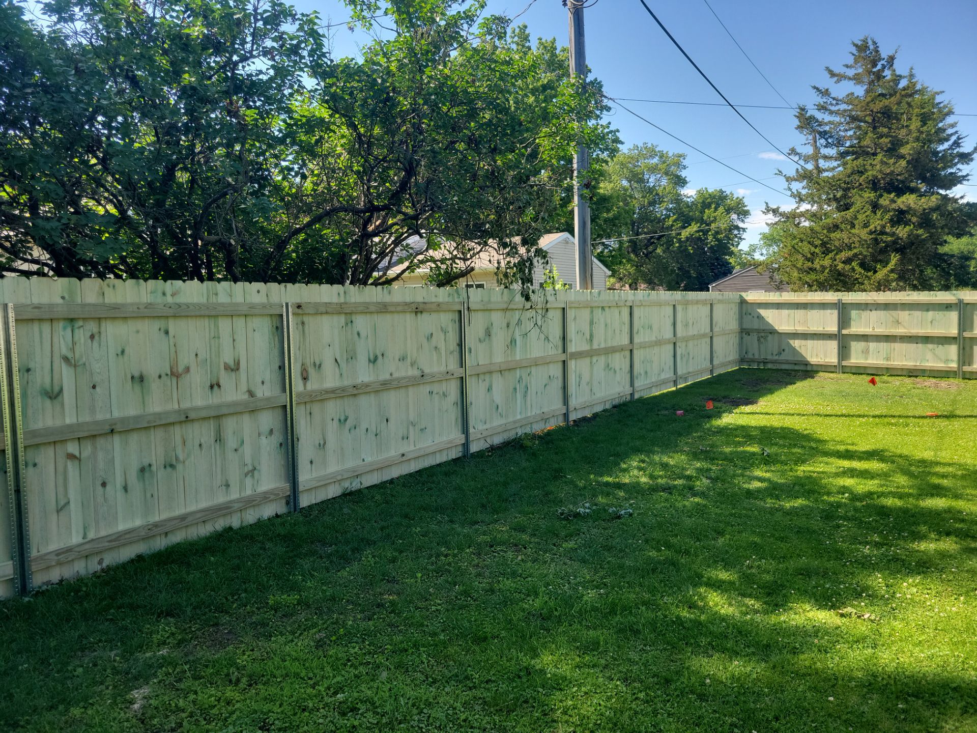 Pressure-Treated Wood Privacy Fence Installation in Charles City by Perfect Picket Fence and Stain