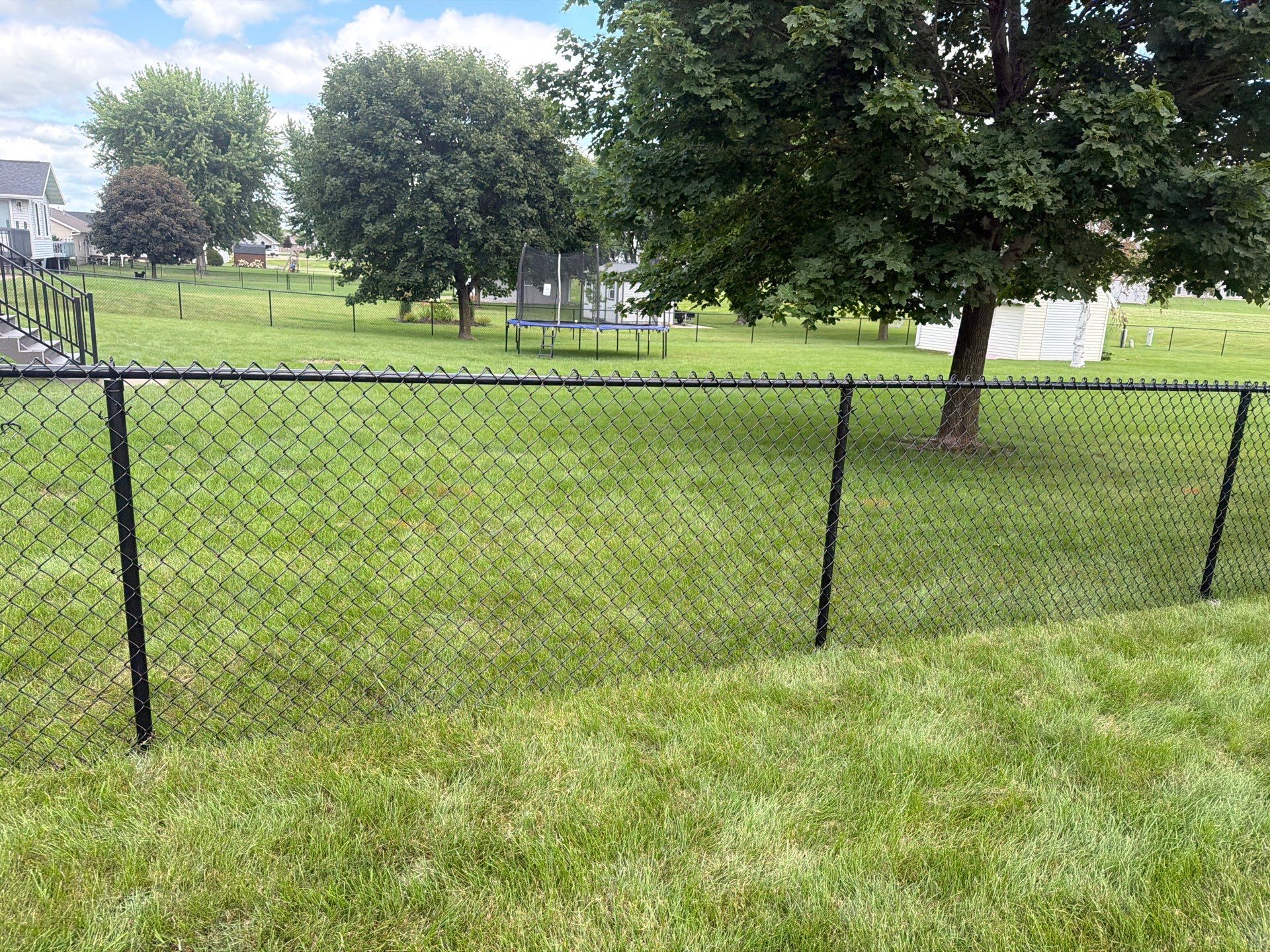 Black Vinyl-Coated Chain Link Fence Installation in Fairbank by Perfect Picket Fence and Stain