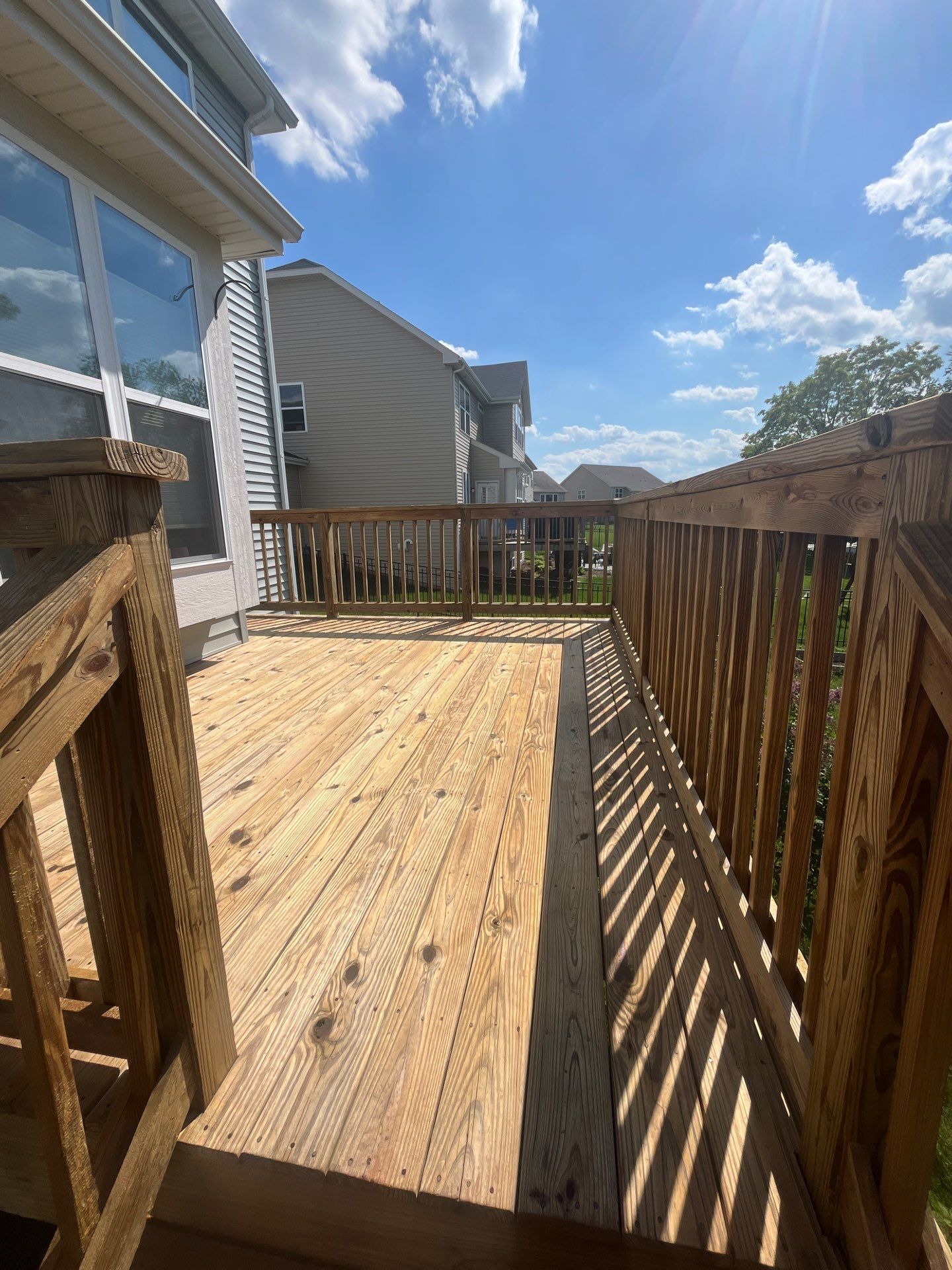 wood deck cleaning and staining by Northern Power Washing LLC.