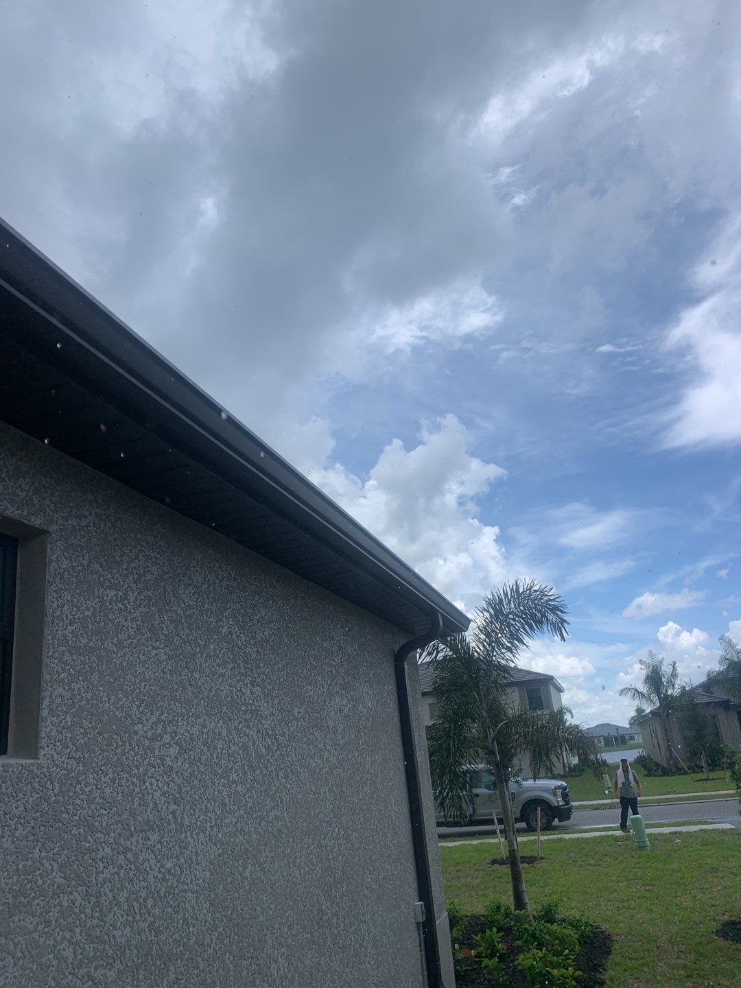 Seamless brown gutter and downspouts installation in Estero, FL  by Gutter Professors
