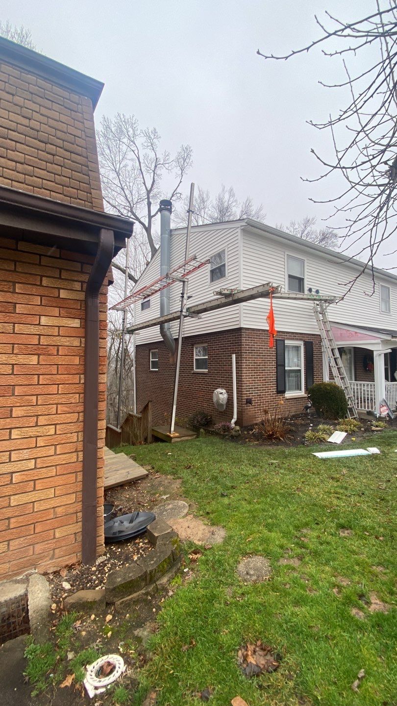 Replace dated vinyl siding with new white exterior Portfolio vinyl siding  by Secure Construction Company Inc