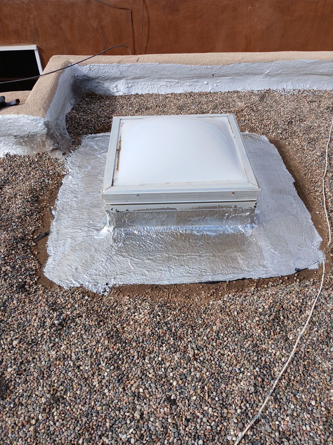Roof Maintenance and Low-E Tempered Glass Skylight Replacement on Gravel Roof in Northwest Albuquerque by Doyle Roof Masters Inc