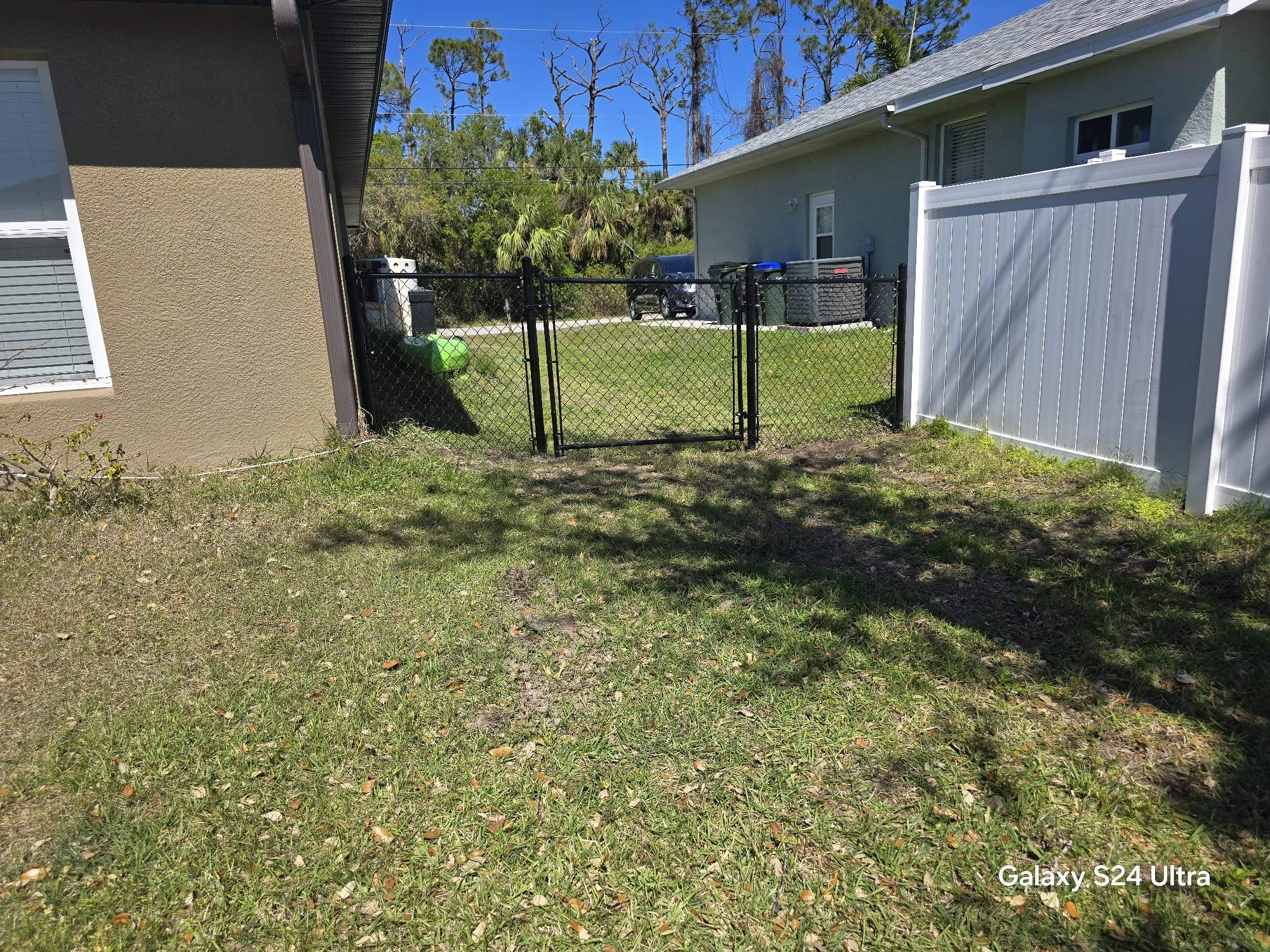 Residential Black Vinyl-Coated Chain Link Fence Installation in North Port by True Fence LLC
