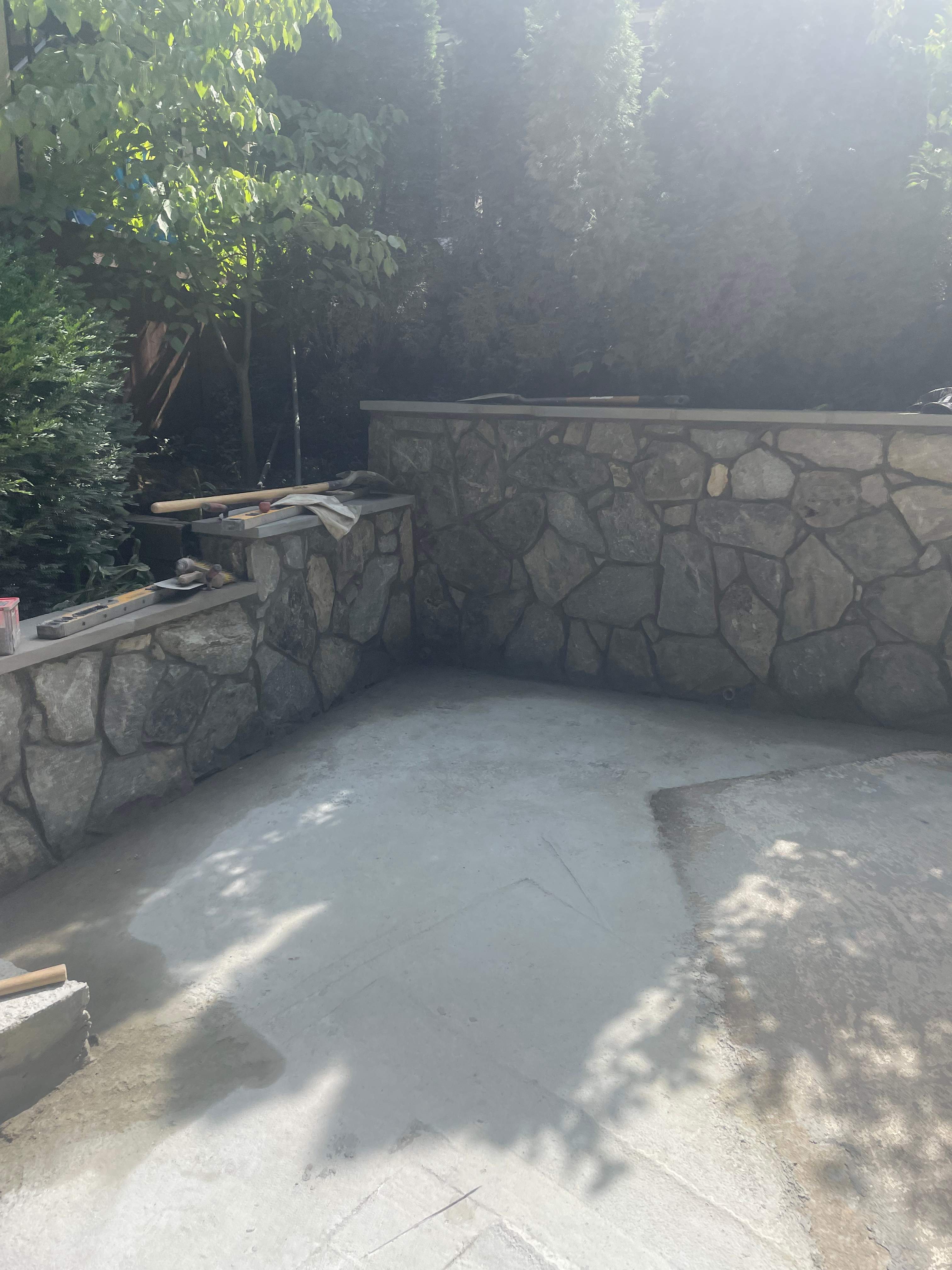 Pool Surround remodel with retaining walls, new waterfall and water slide by Fairfax Contractors, LLC