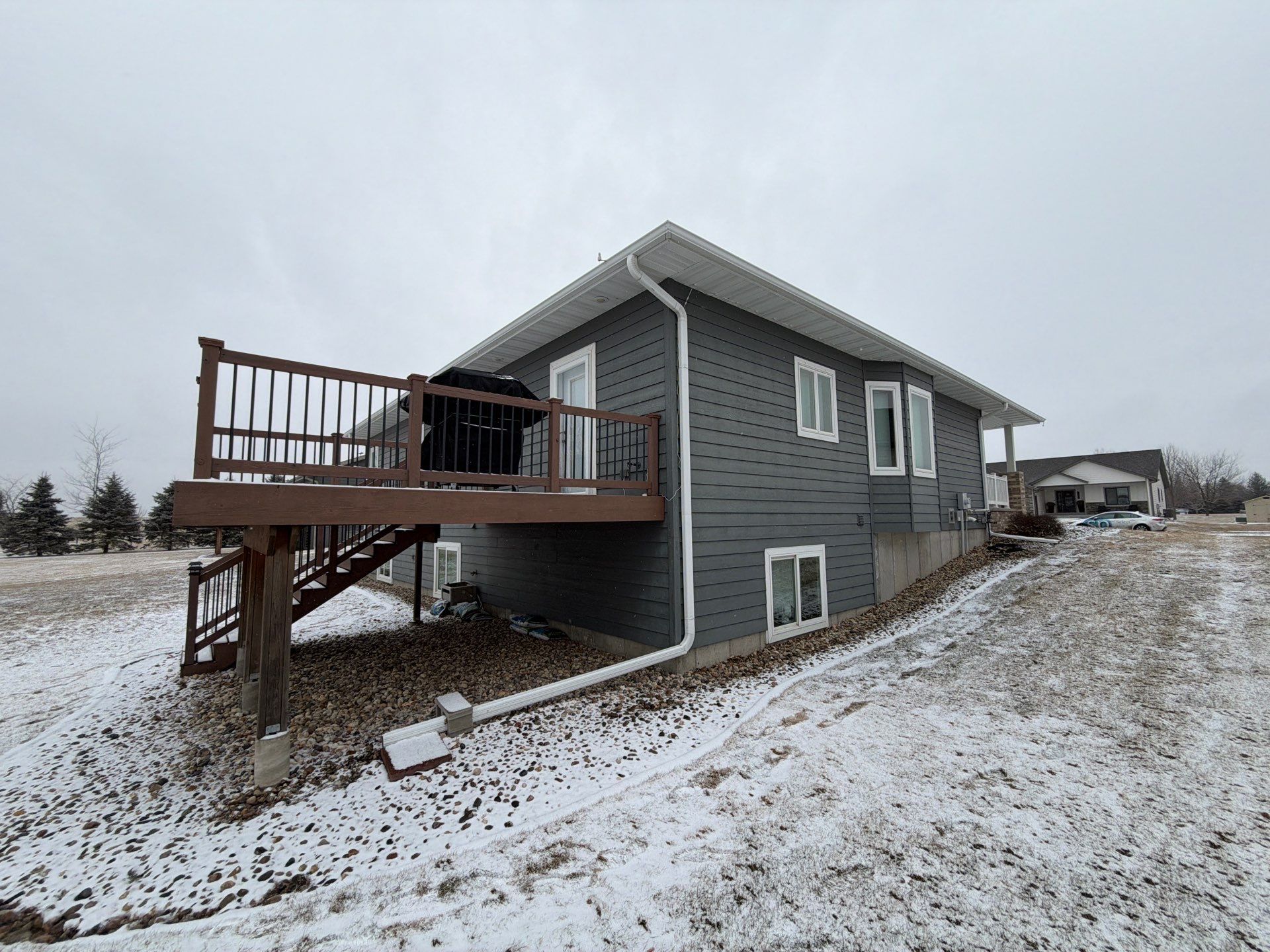 Madison Exterior Remodel with Dark Gray Siding and Stone Accents by Select Painting, Coatings & Garage Cabinets