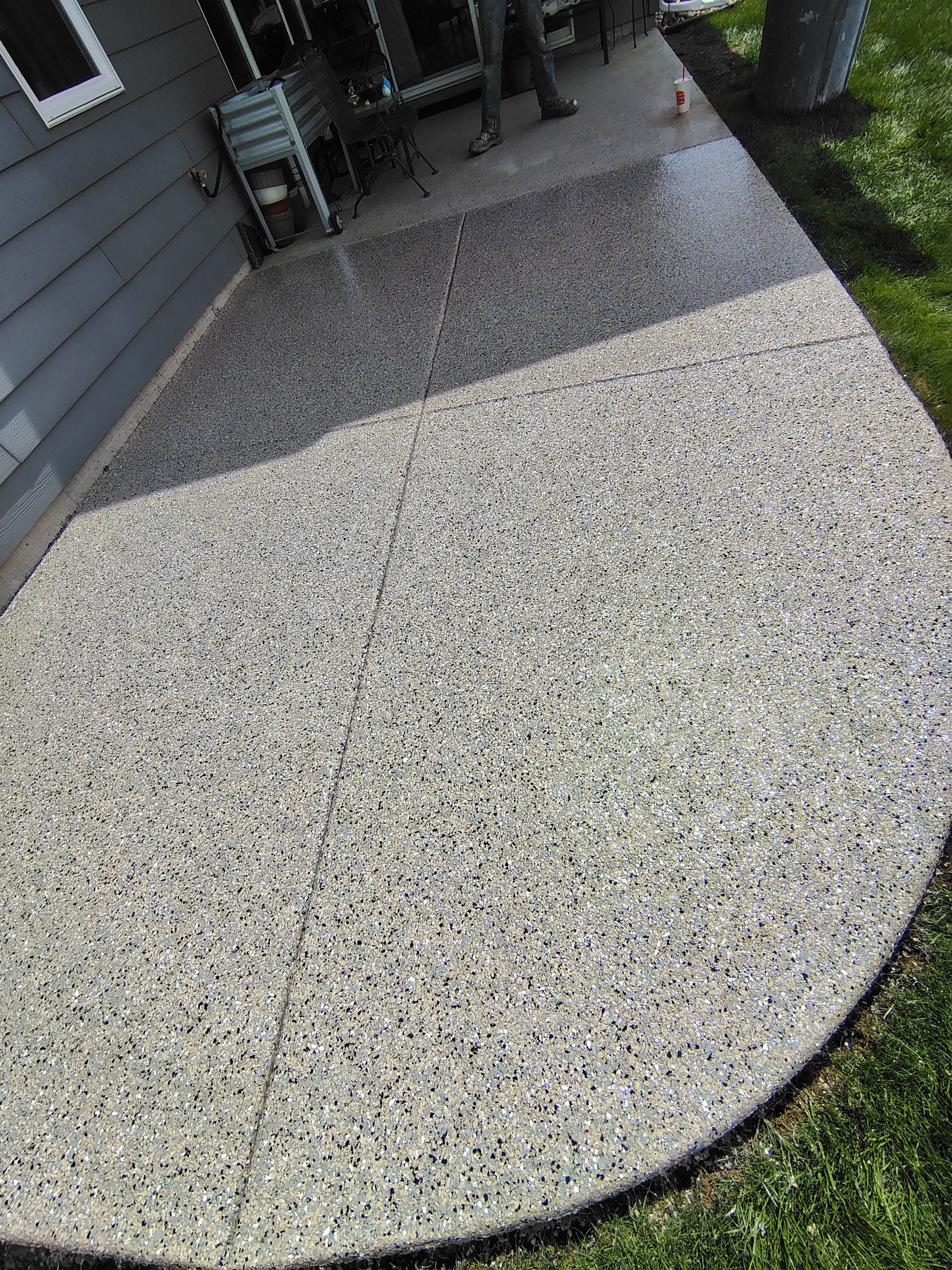 Speckled Concrete Patio Coating Installation in Sioux Falls by Select Painting, Coatings & Garage Cabinets