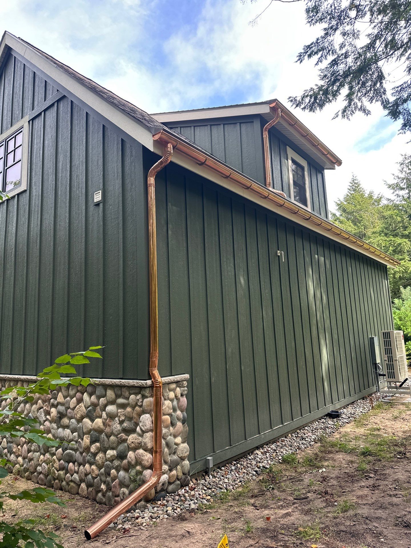 Copper Gutter and Downspout Installation for Omena Residence by Rainbow Seamless Systems