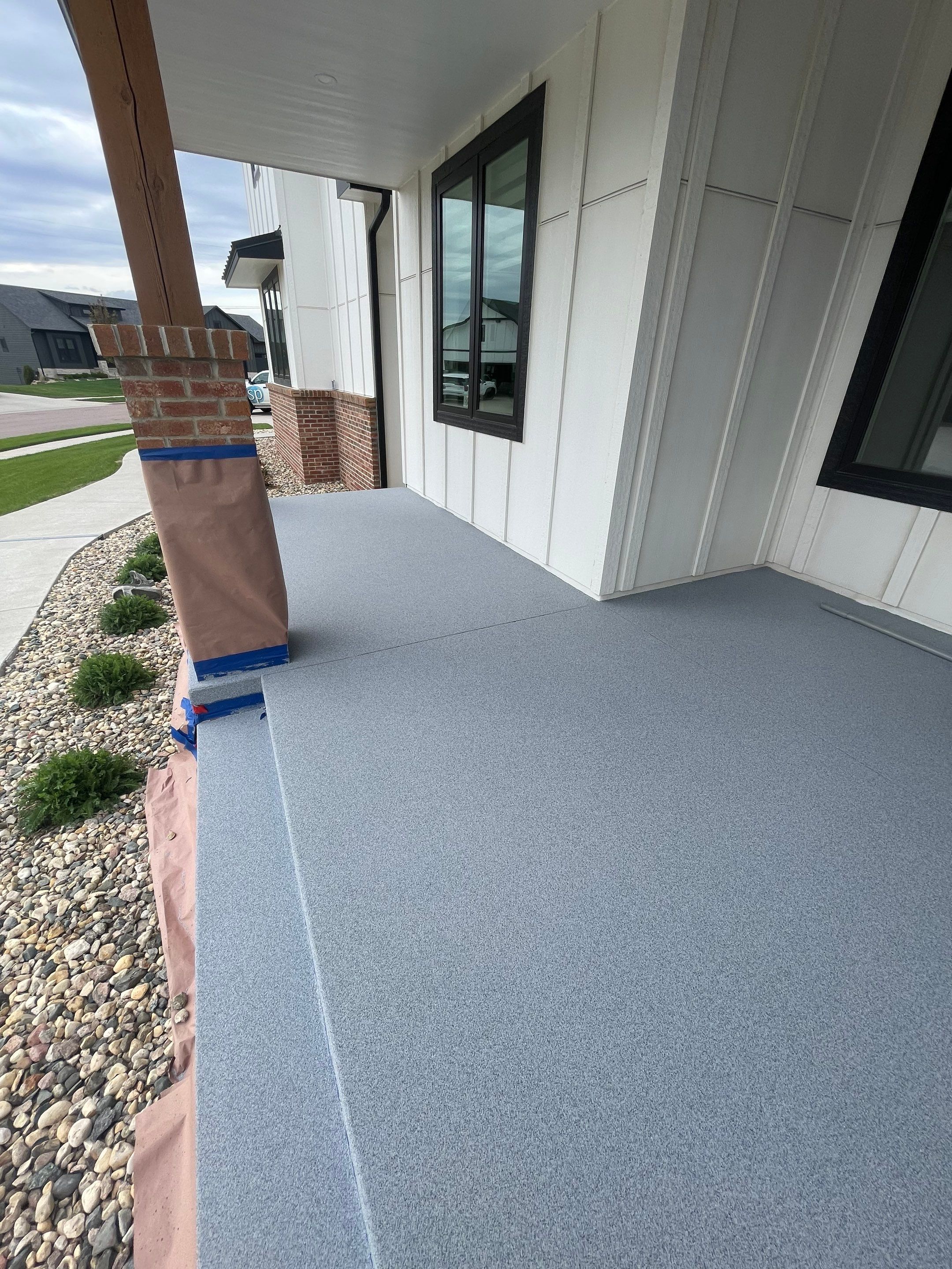Grey Speckled Concrete Porch Coating for Sioux Falls Home by Select Painting, Coatings & Garage Cabinets