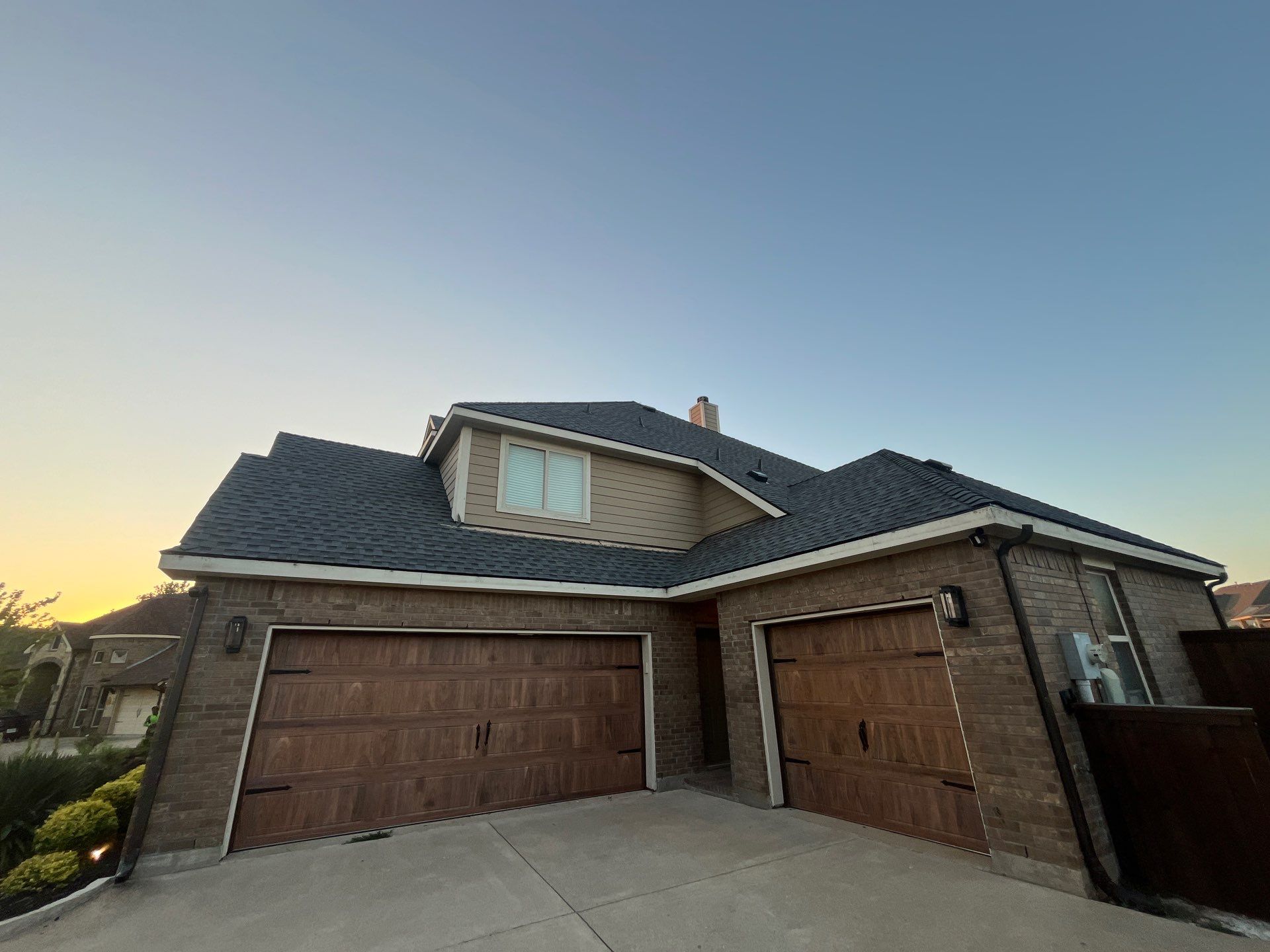 Medium brown brick with GAF Pewter Gray  by Tejas Roofworks + Restoration