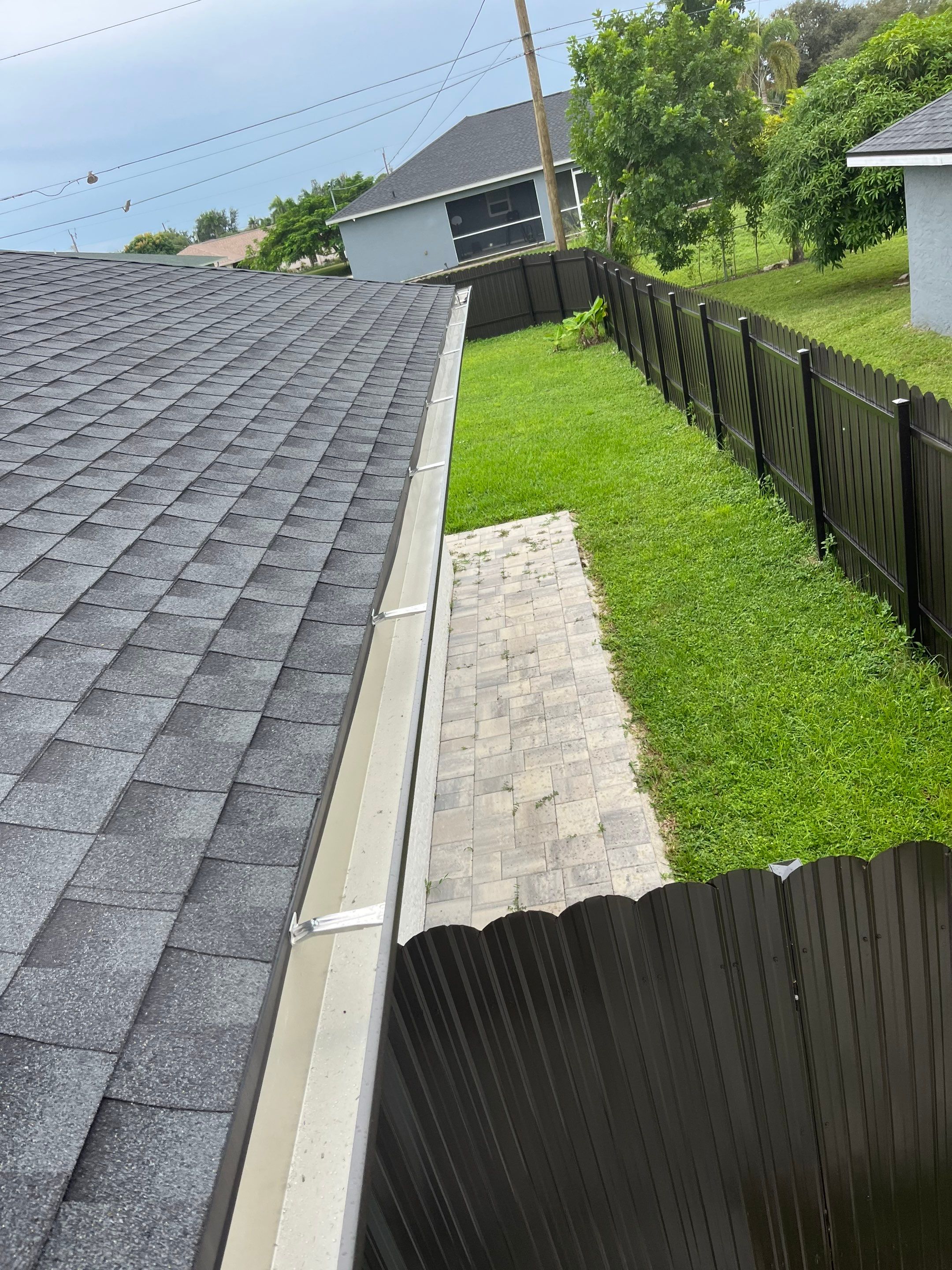 Black Seamless Gutters for a Modern Look in Cape Coral FL by Gutter Professors