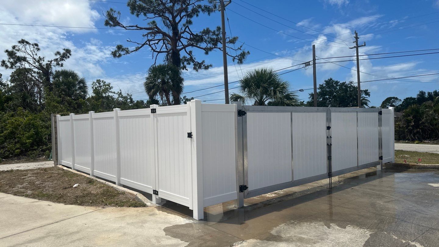 Commercial Chainlink and Vinyl Fence With Aluminum Framed Gates On Dumpster Enclosure by Asap fence and gates, LLC