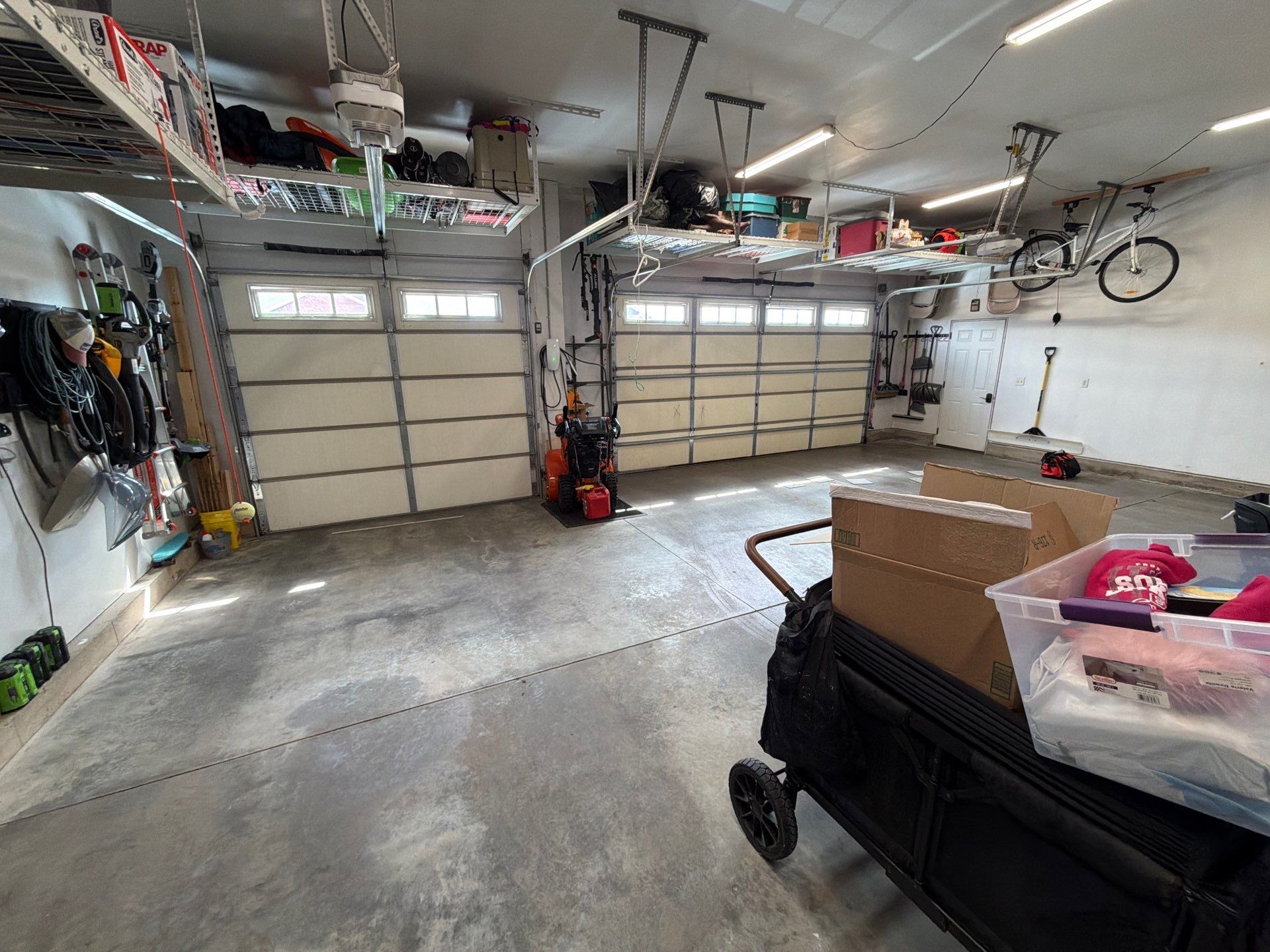 Feather Gray Epoxy Floor Coating Installation in Sioux Falls by Select Painting, Coatings & Garage Cabinets
