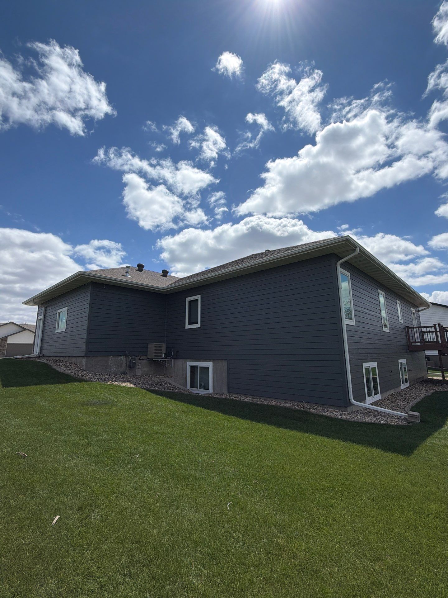 Madison Exterior Remodel with Dark Gray Siding and Stone Accents by Select Painting, Coatings & Garage Cabinets