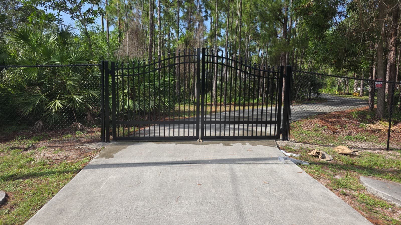 Automated Driveway Gate and Black Chain Link Fence Installation by True Fence LLC