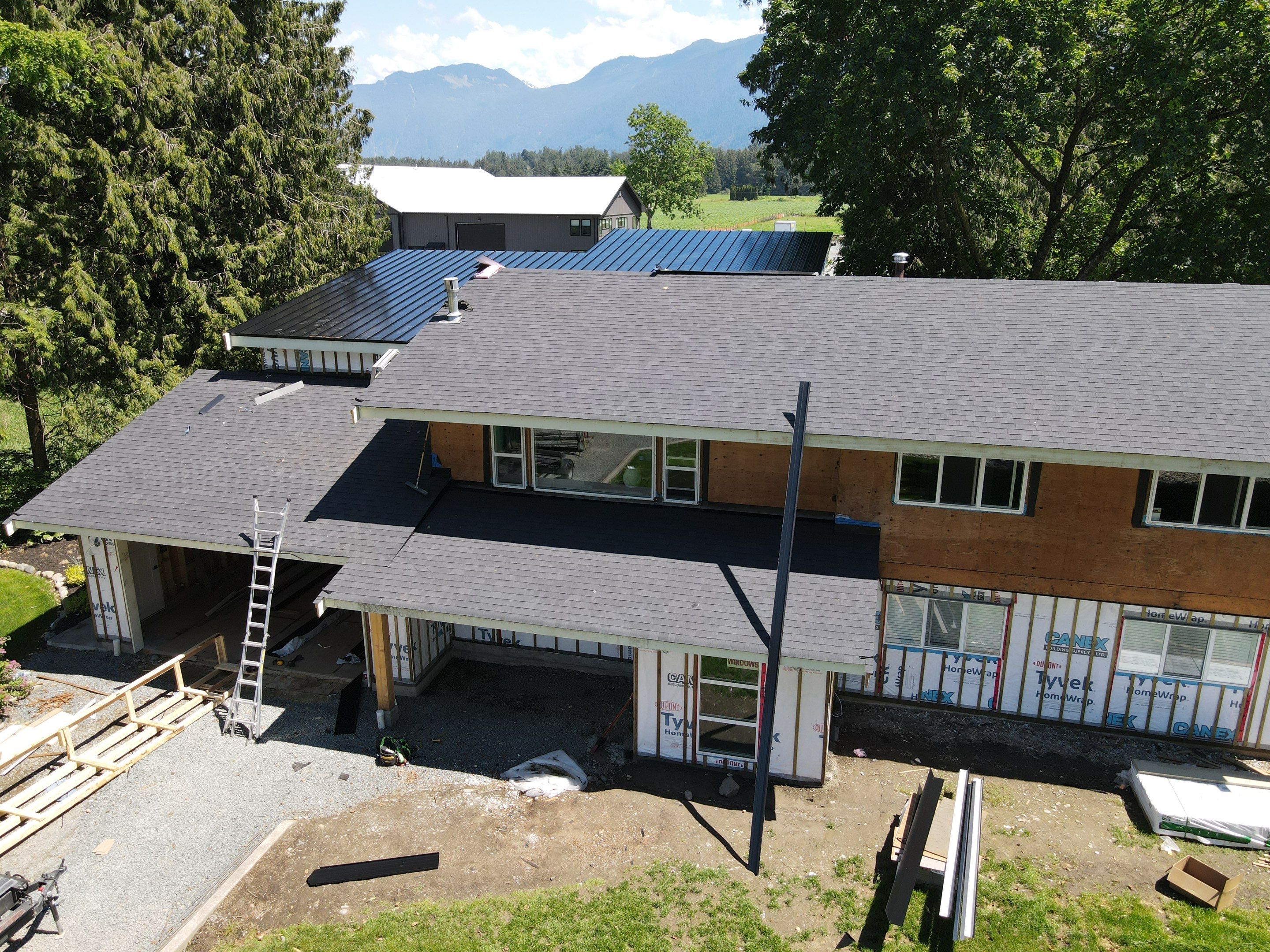 Residential Roofing Installation using 12" Prolok metal, shingles and Torch on roofing by Top Notch Roofing Inc