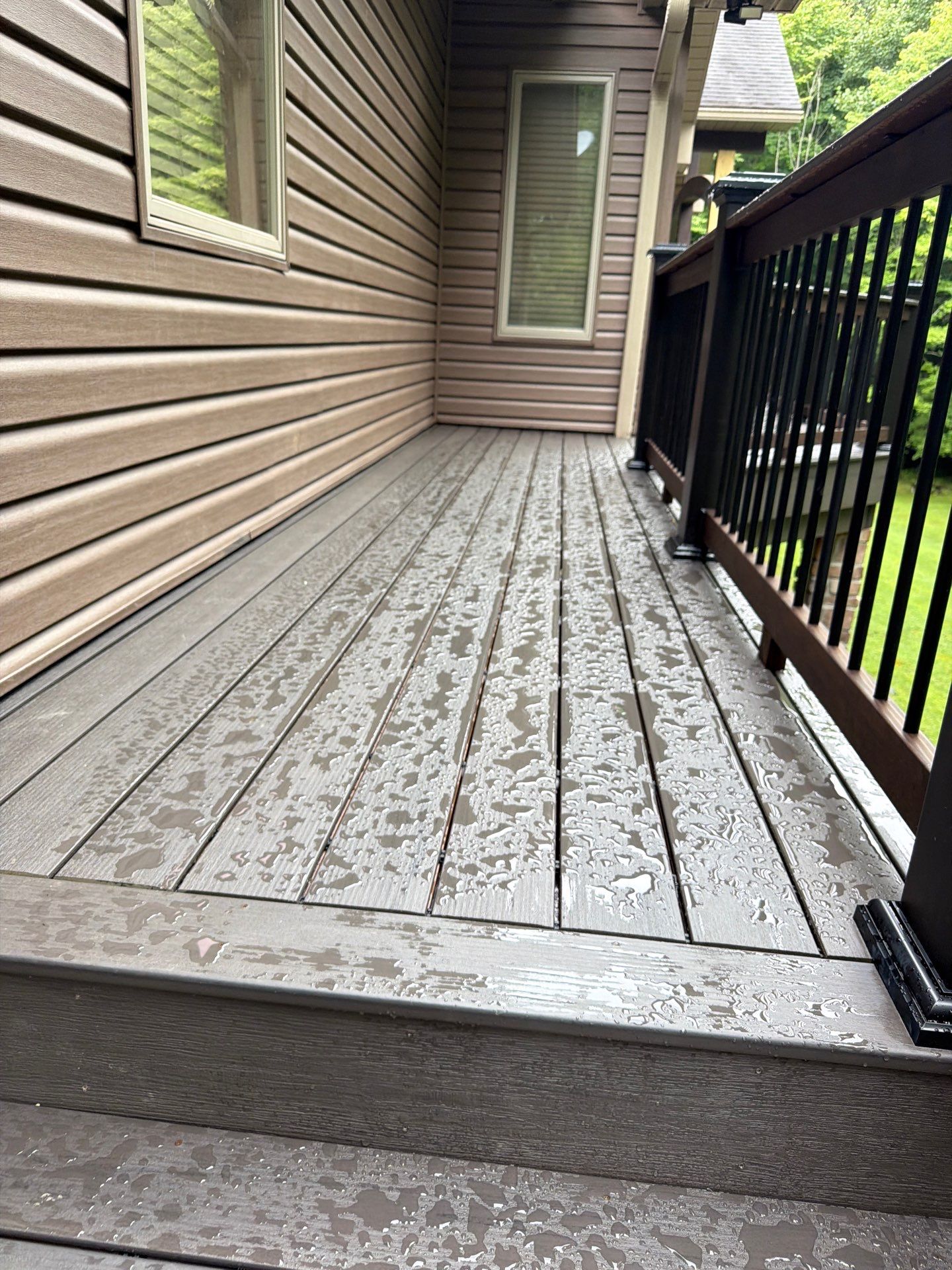 Custom Composite Deck Construction with Stone Pillars in Fayetteville by Walnut Hollow Decks & Outdoor Living