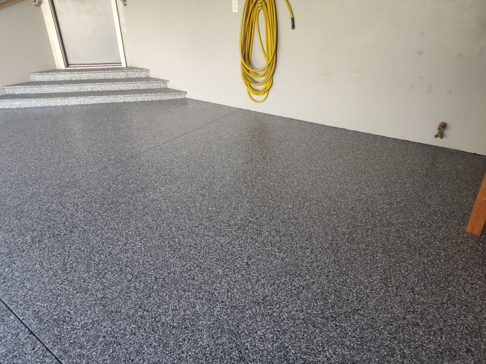 Close Up View of This Customer's New Flake Coating by Revival Concrete Coatings, LLC