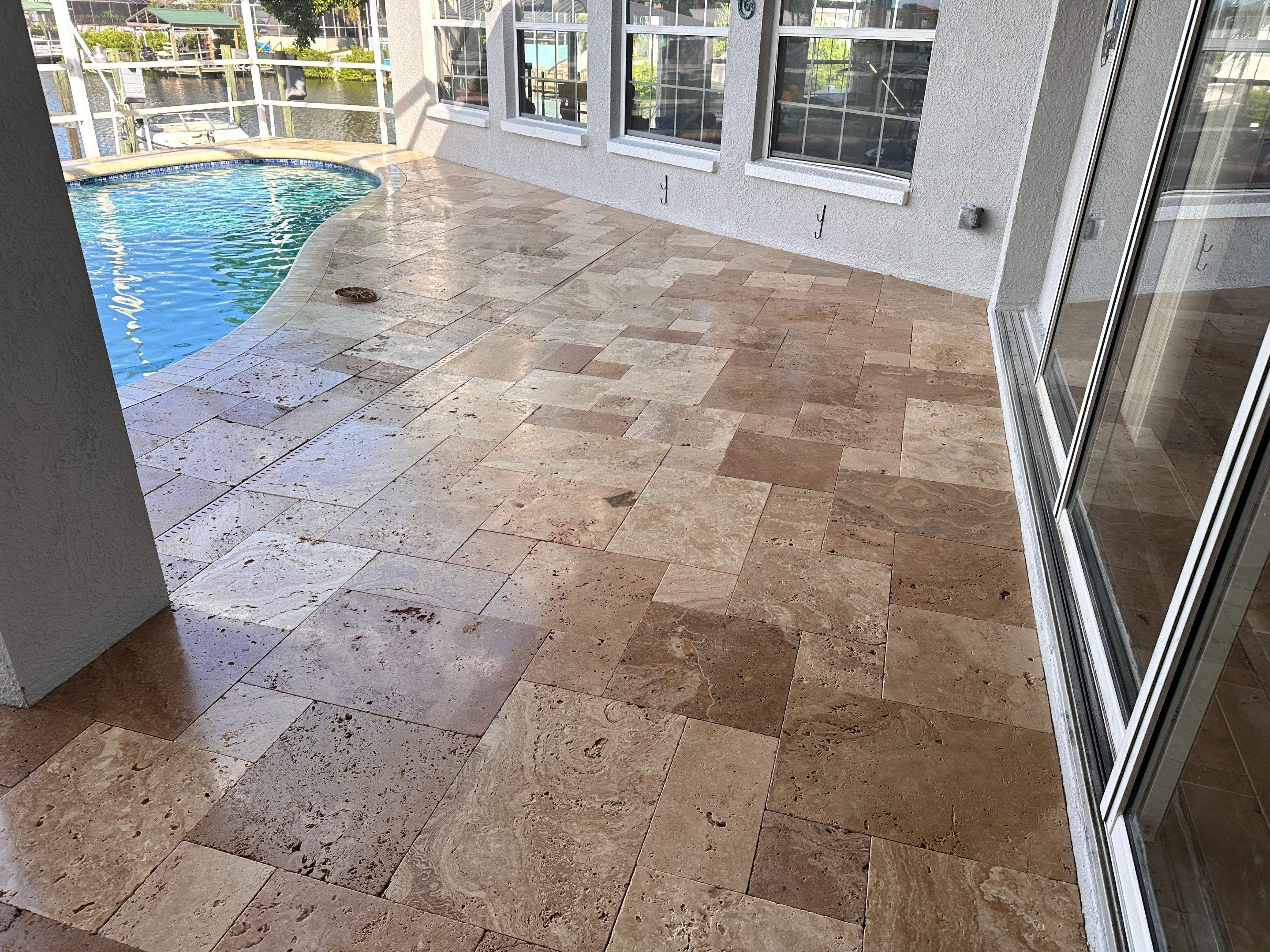 Travertine Sealing and Stripping for a Waterfront Pool Deck in Apollo Beach by Supreme Paver Experts