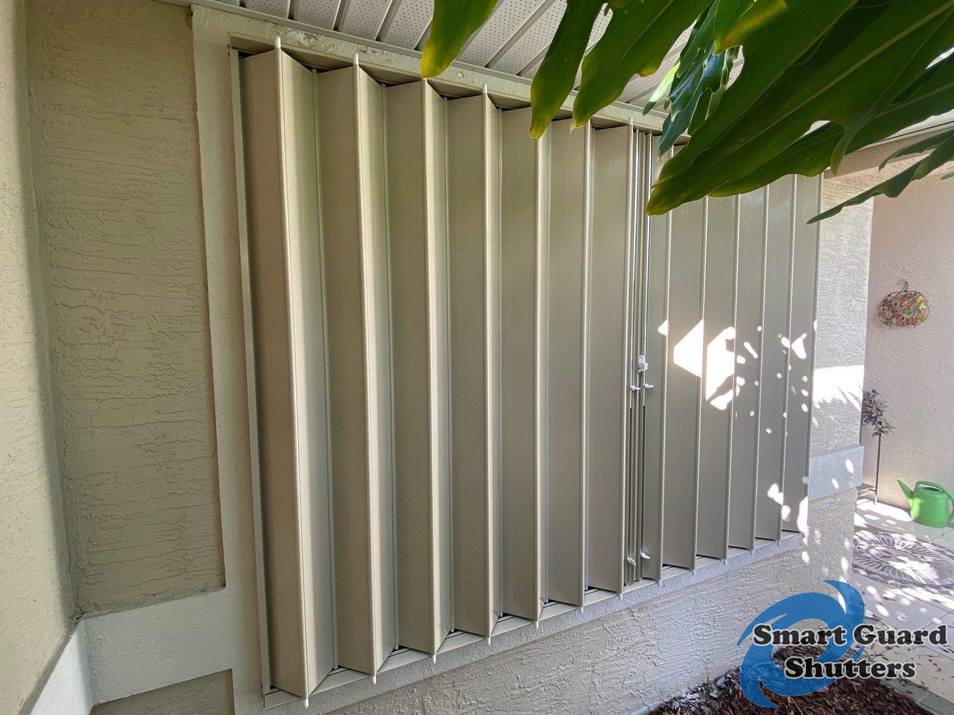 Accordion Shutters in Beige by Smart Guard Shutters