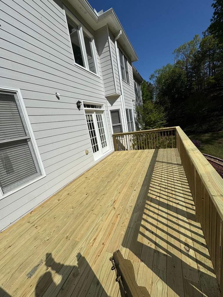 Kennesaw Deck Renovation Featuring Pressure-Treated Lumber and Metal Railings by Swift Home Renovations