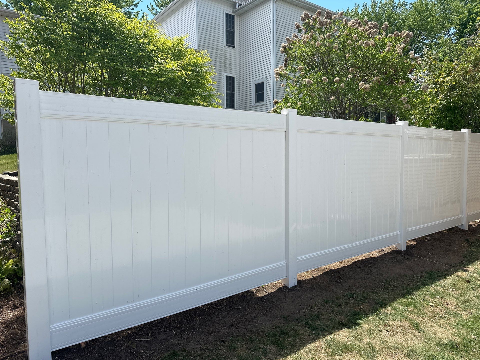White Vinyl Privacy Fence Installation in Lawler, IA by Perfect Picket Fence and Stain